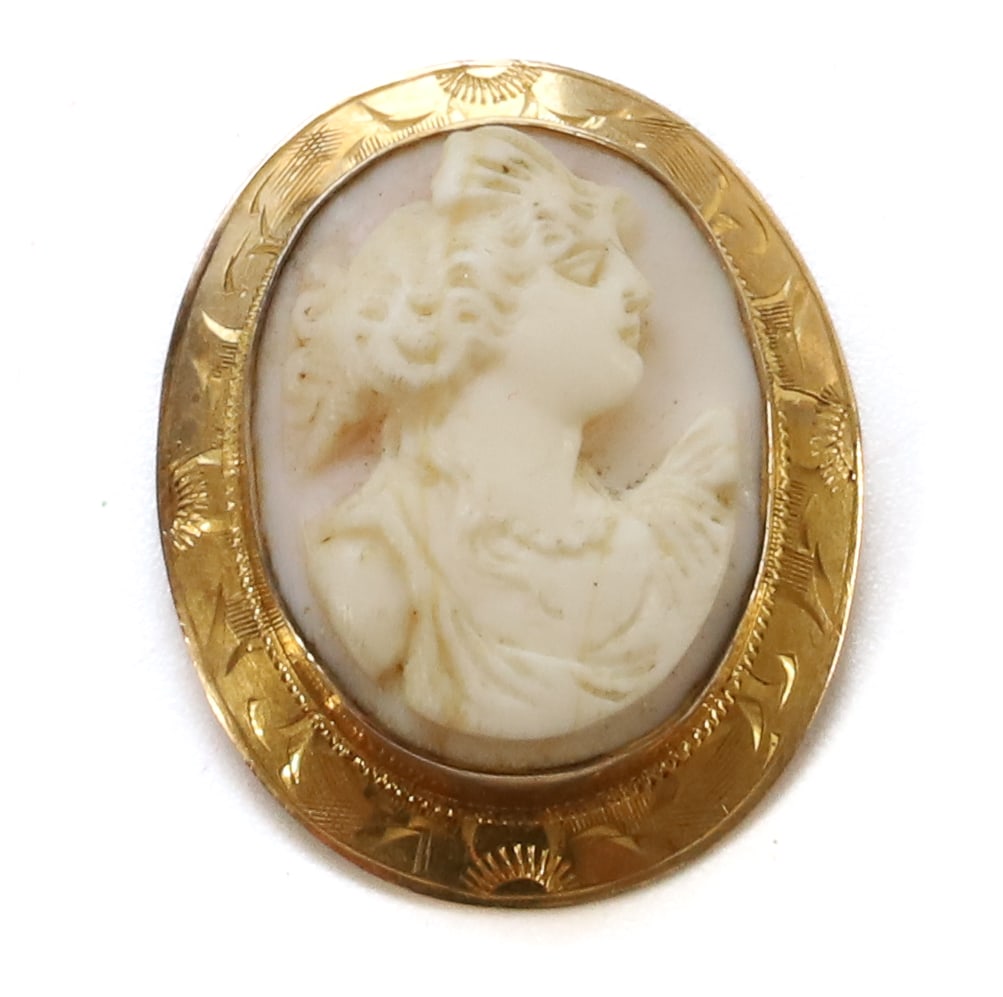 10K GOLD CAMEO: OVAL SHAPE, YELLOW GOLD ENGRAVED MARKED 1OK SHELL CAMEO 1 1/4" X 1" PLEASE READ CAREFULLY BEFORE BIDDING. ALL PURCHASES OF GOLD OR SILVER VIA LIVE AUCTIONEERS MUST BE PAID FOR THROUGH THE LIVE AUCTION