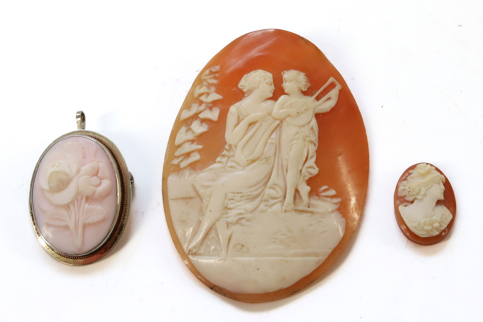 (3) CAMEOS: OVAL SHELL CAMEO WITH WOMAN,CHILD MUSICAL INSTRUMENTS, SHELL ROSE CAMEO STERLING SETTING BROOCH AND LOOSE SMALL SHELL CAMEO PLEASE READ CAREFULLY BEFORE BIDDING. ALL PURCHASES OF GOLD OR SILVER VIA LI