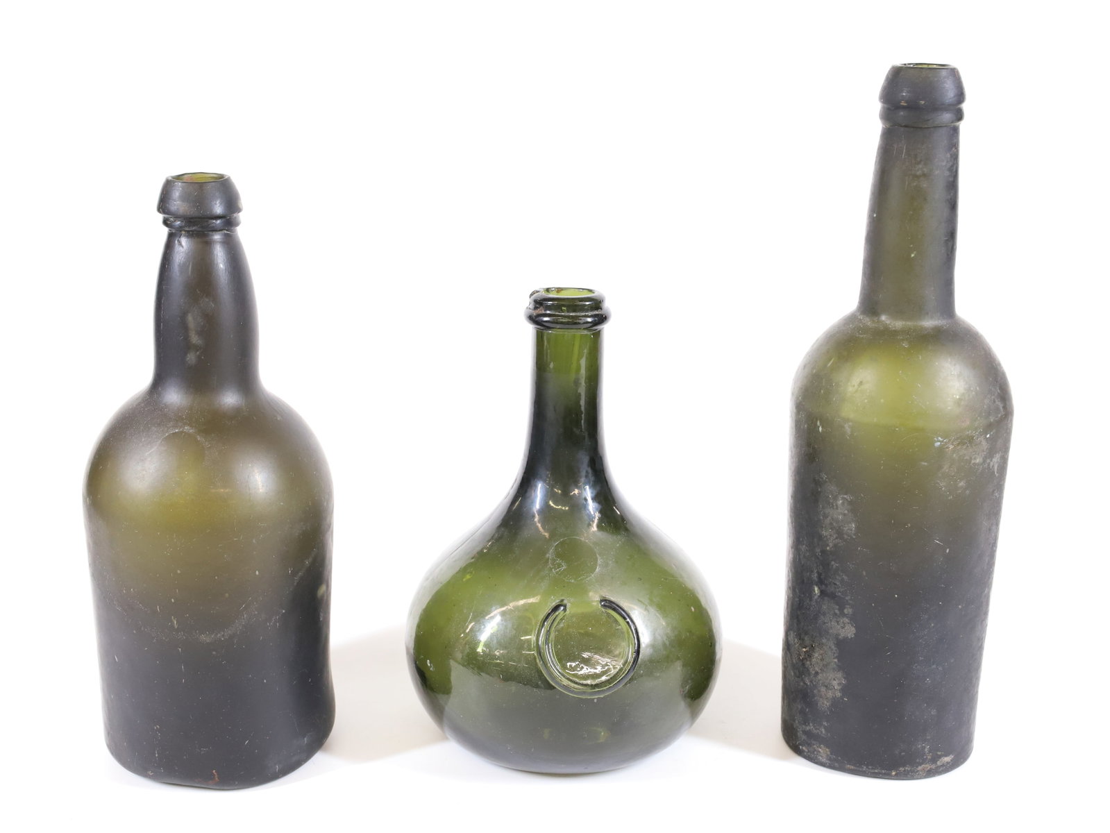 LOT OF 19TH C. BOTTLES: COMMERCIAL BOTTLES IN DEEP OLIVE GREEN. 7" TO 10 3/4" HEIGHTS. PLEASE READ CAREFULLY - Terms for Purchasing and Shipping of Auction Items. Please read carefully before bidding. All payments for purcha