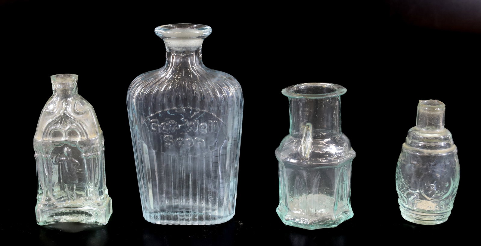 LOT OF 19TH C. BOTTLES: (4) SMALL BLOWN GLASS BOTTLES. AQUA. LARGEST READS "GET WELL SOON" AND MRKD. ON BOTTOM. 3" TO 4 3/4" HEIGHTS. PLEASE READ CAREFULLY - Terms for Purchasing and Shipping of Auction Items. Please read ca