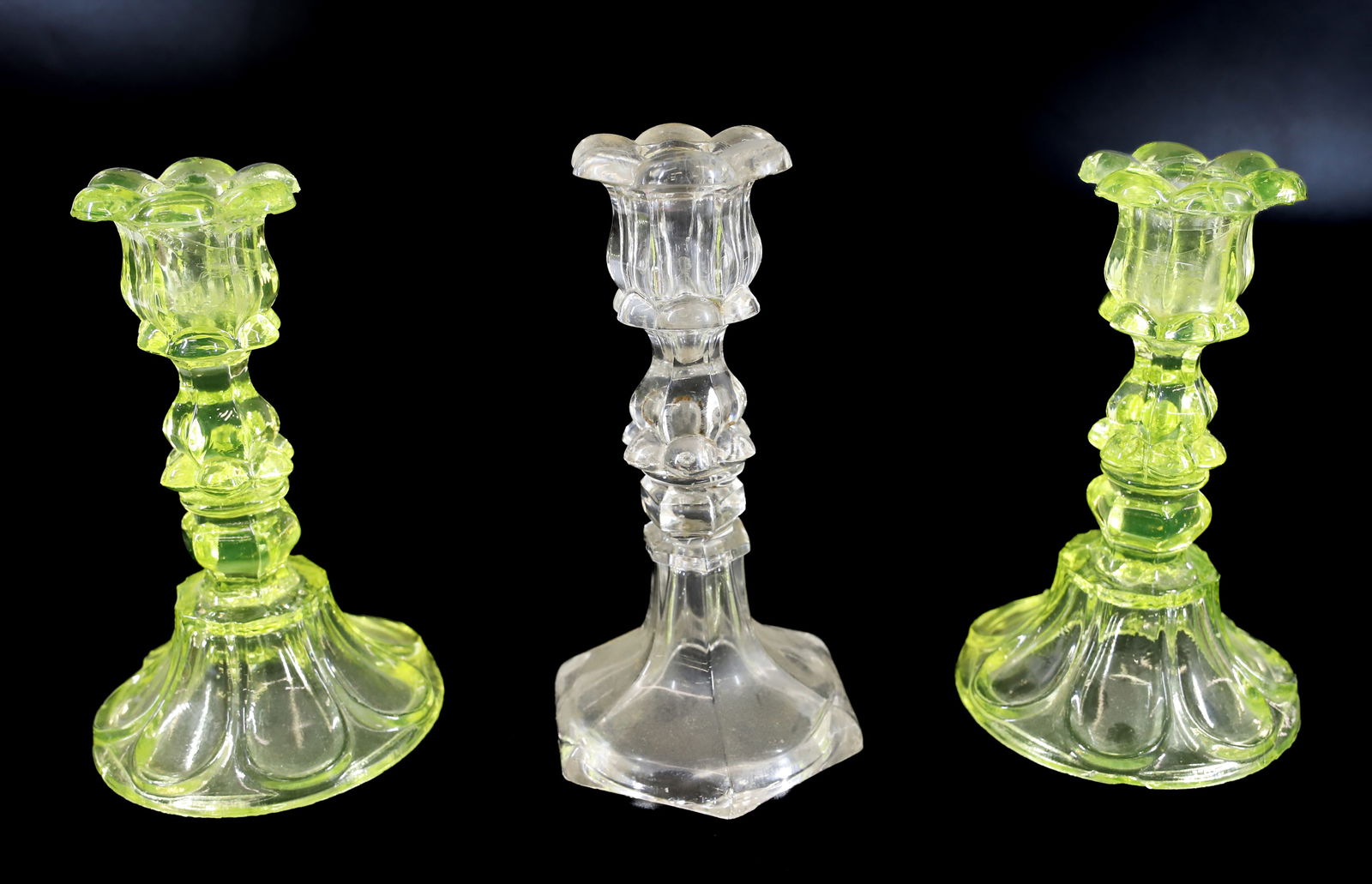 PAIR OF CANARY GLASS CANDLESTICKS: 6 3/4" H. PLUS, SINGLE CLEAR GLASS CANDLESTICK. 7" H. PLEASE READ CAREFULLY - Terms for Purchasing and Shipping of Auction Items. Please read carefully before bidding. All payments for purchases will