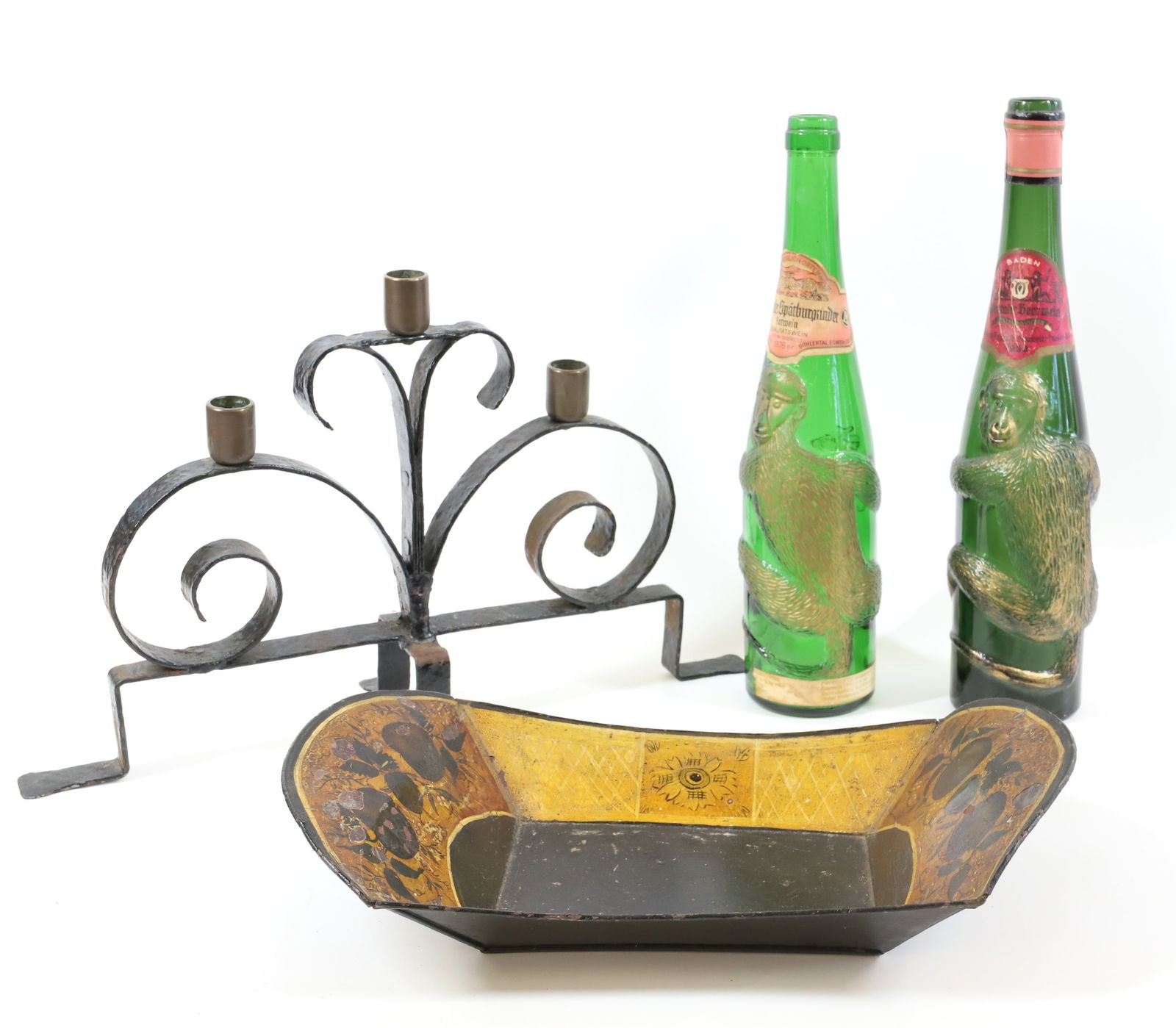 TOLEWARE TRAY, MONKEY BOTTLES AND CANDLEHOLDER: PAINTED TIN BREAD TRAY WITH FLORAL MOTIF 13 3/4" L., TWO EMBOSSED GERMAN MONKEY WINE BOTTLES. WROUGHT IRON CANDLE HOLDER WITH BRASS HOLDERS. 10" X 16 1/2". PLEASE READ CAREFULLY - Terms for Purchasing