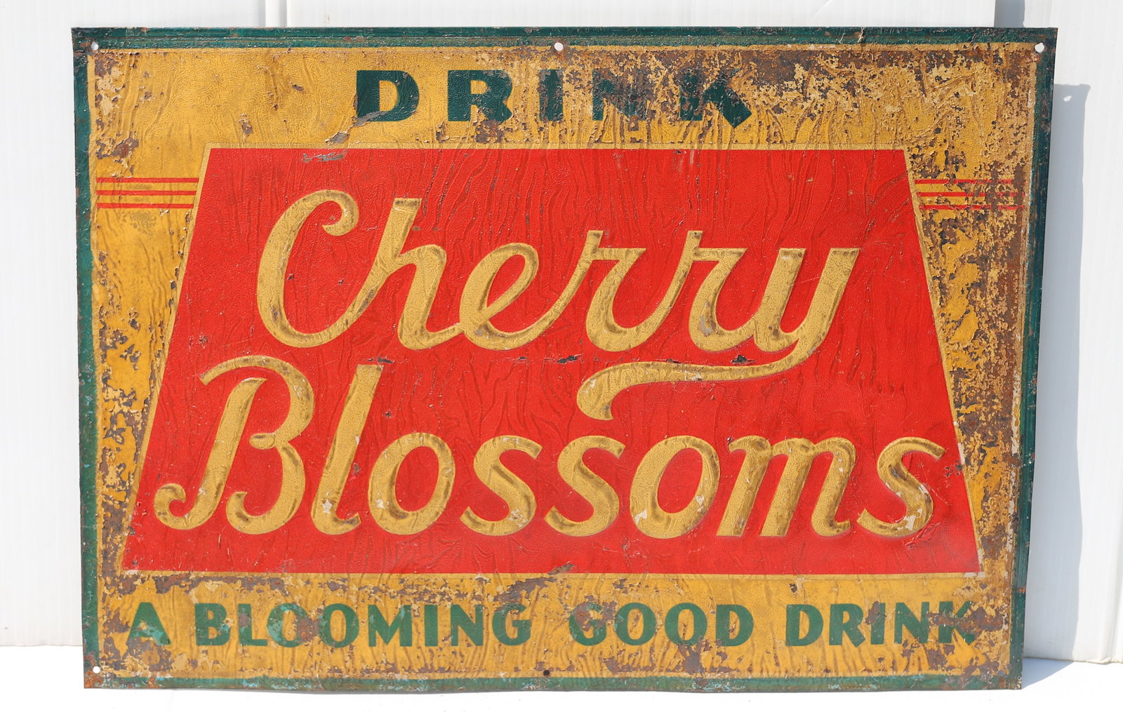 DRINK CHERRY BLOSSOMS TIN SIGN: PAINTED TIN "A BLOOMING GOOD DRINK". 13 1/4" X 19". PLEASE READ CAREFULLY - Terms for Purchasing and Shipping of Auction Items. Please read carefully before bidding. All payments for purchases will be