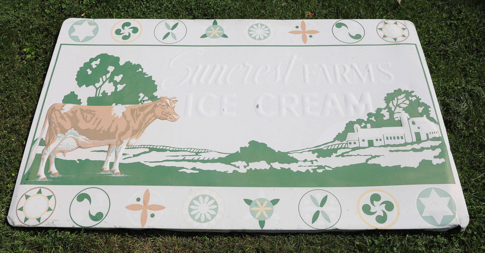 SUNCREST FARMS ICE CREAM SIGN: EMBOSSED PAINTED METAL. 34" X 55 1/2". PLEASE READ CAREFULLY - Terms for Purchasing and Shipping of Auction Items. Please read carefully before bidding. All payments for purchases will be made through