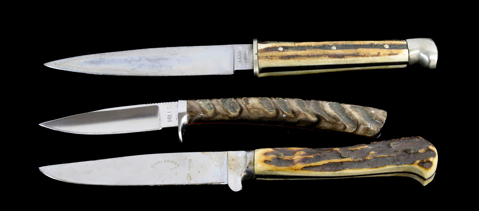 (3) CUSTOM HUNTING KNIVES: INCLUDING: G.C. CO. #438 WITH ANTLER HANDLE, MILLS CUSTOM SKINNER WITH BONE HANDLE AND CARL EVERTS, SOLINGEN WITH ANTLER HANDLE. TOTAL SIZE 7 1/2" TO 9" . Registration: Terms:
