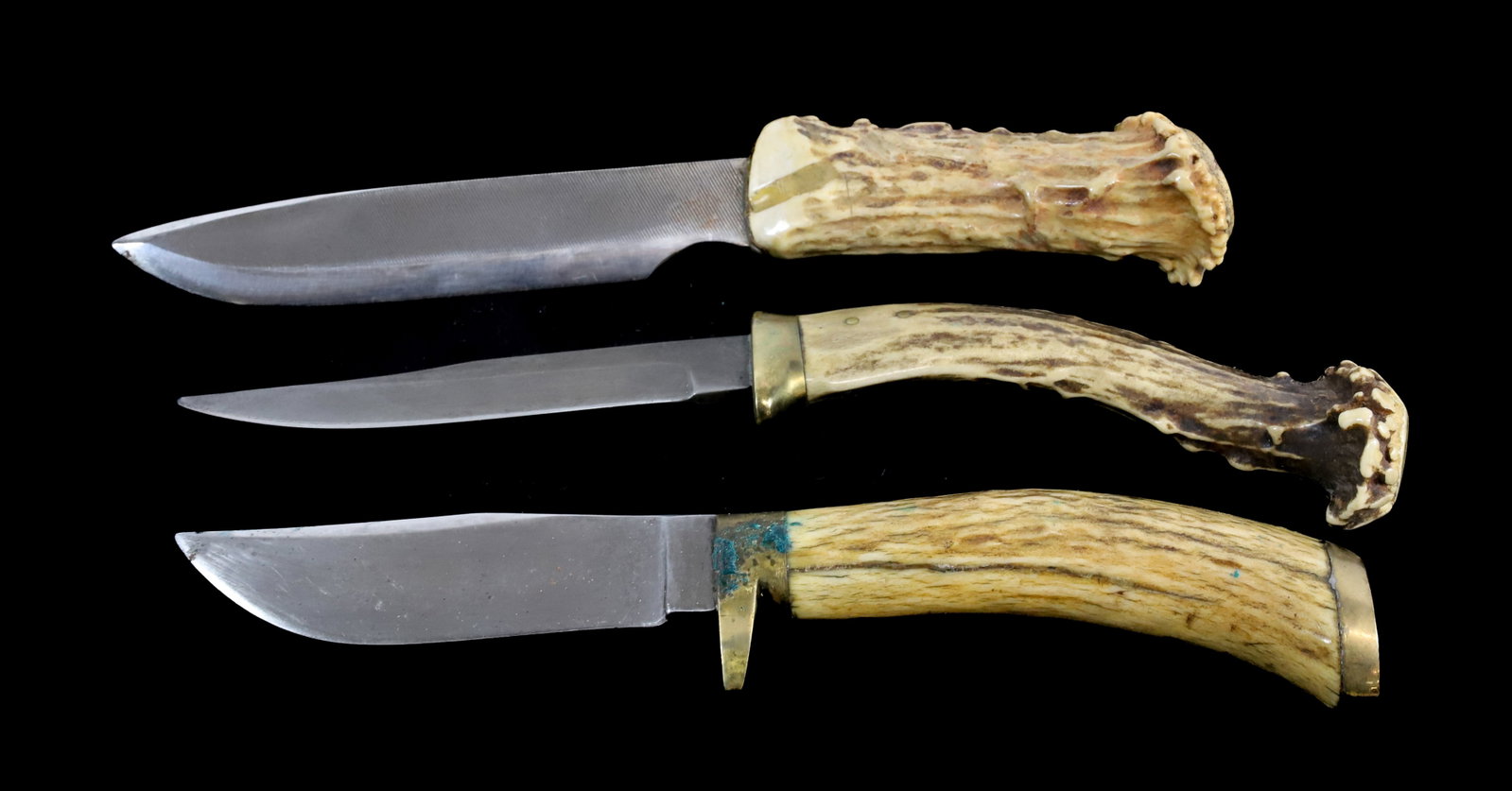 (3) CUSTOM MADE HUNTING KNIVES: ALL ARE UNMARKED WITH ANTLER HANDLES AND BRASS TRIMS. ONE BLADE IS MADE FROM FILE. 8 1/2" TO 9 1/4" TOTAL LENGTHS. Registration: Terms: