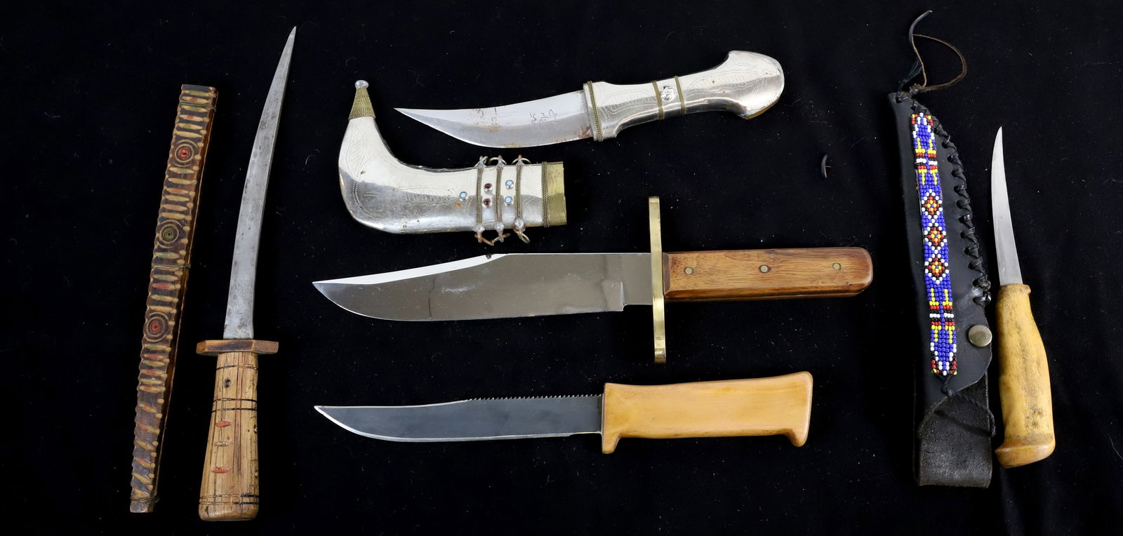 UNUSUAL KNIFE LOT: (5) INCLUDING: MIDDLE EASTERN KNIFE WITH DECORATED SHEATH, ISLAMIC FILLET KNIFE WITH DECORATED BLADE, FILLET KNIFE WITH BEADED SHEATH, HANDMADE FILLET KNIFE AND BOWIE KNIFE (13" L.) Registration: Term
