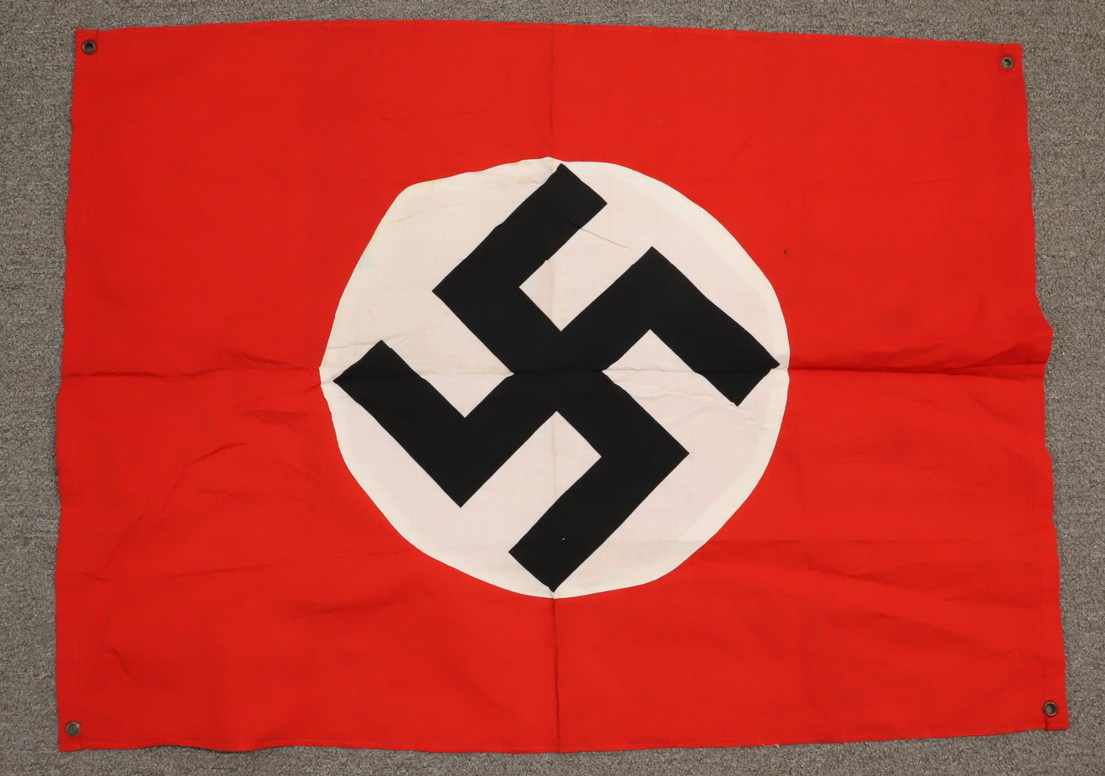 WWII NAZI GERMANY FLAG: COTTON WITH SEWN ON MEDALLION. METAL GROMMETS. SIZE 28" X 38". Registration: Terms: