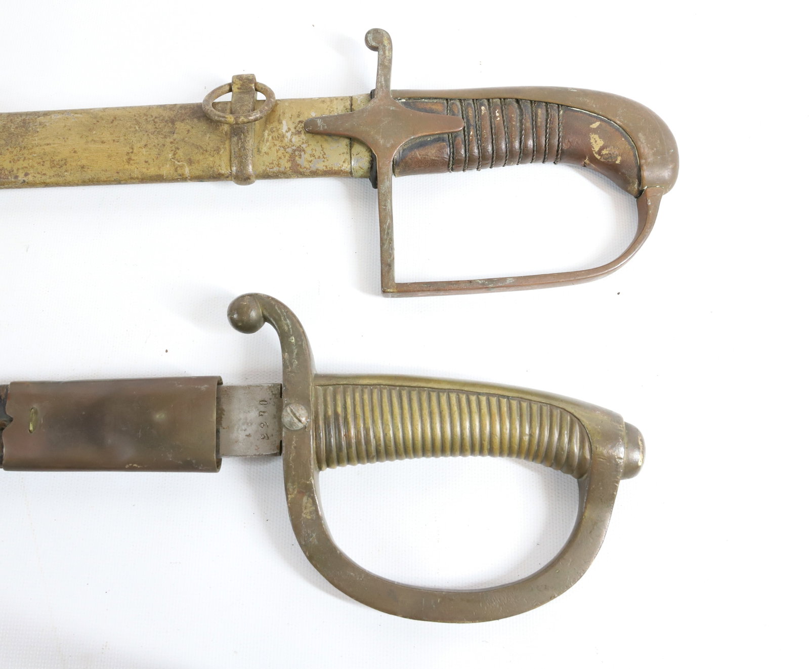 (2) CAVALRY SWORDS: INCLUDING: ONE MRKD. ARTILLERIAFOR NACIONAL, TOLEDO #9970 WITH LEATHER SCABBARD 33 1/2" TOTAL LENGTH.OTHER MRKD. WAREZAWA WITH IMP. INITIALS ON GUARD P.W.SL.285. 36" L. Registration: Terms:
