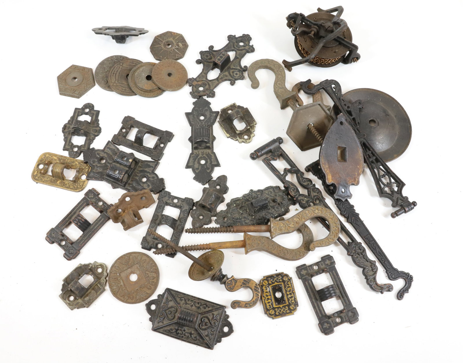 LIGHTING HARDWARE GROUP: (5) CAST IRON EASTLAKE CHANDELIER HOOKS, (7) CAST IRON ESCUTCHEONS,(15)CAST IRON EASTLAKE SWING ARM BRACKETS, (3) CAST IRON EASTLAKE SWING OUT HOOKS 2 1/2" TO 9 1/4" Terms: PLEASE READ CAREFULLY -THIS