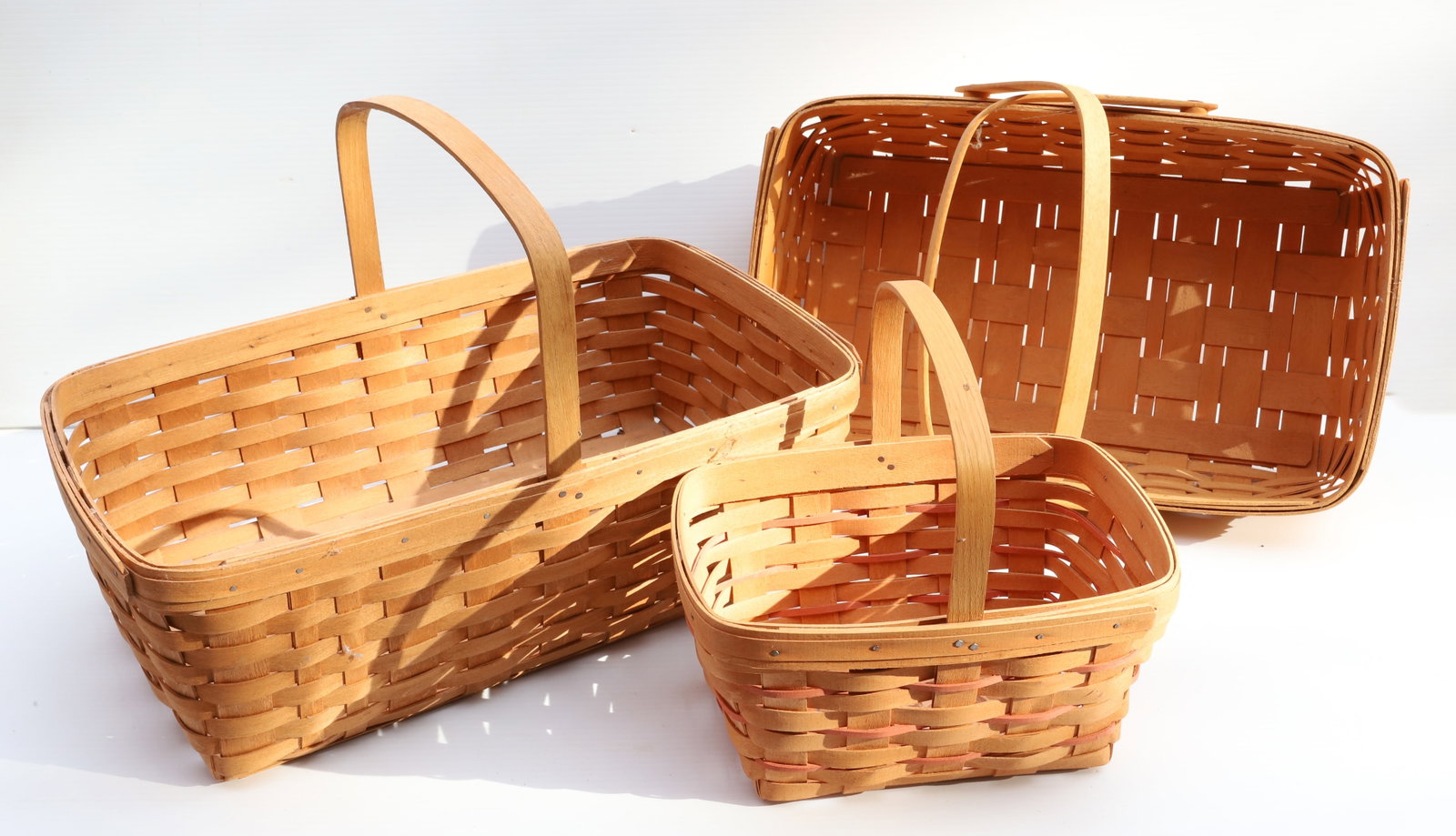 (3) LONGABERGER BASKETS: BENTWOOD HANDLES, 1987, 1988, AND 1995 - LARGEST 19" L Terms: PLEASE READ CAREFULLY -THIS IS AN ONLINE ONLY AUCTION. Terms for Purchasing and Shipping of Auction Items. Please read carefully before bi