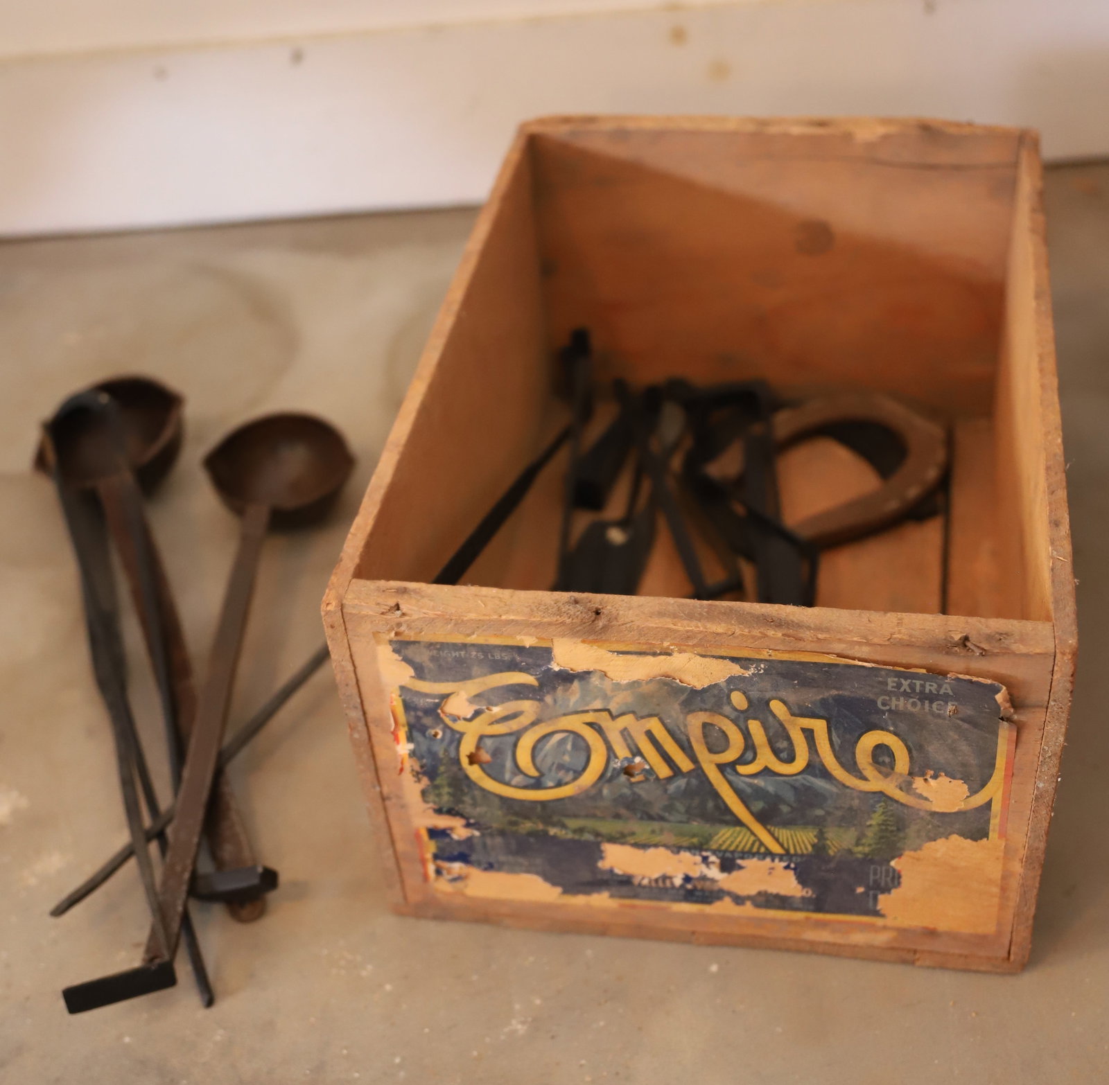WOODEN ADVERTISING CRATE AND IRON FOUNDRY TOOLS: LADLES, SMOOTHERS, AND MORE - CRATE 17" Terms: PLEASE READ CAREFULLY -THIS IS AN ONLINE ONLY AUCTION. Terms for Purchasing and Shipping of Auction Items. Please read carefully before bidding. All paym