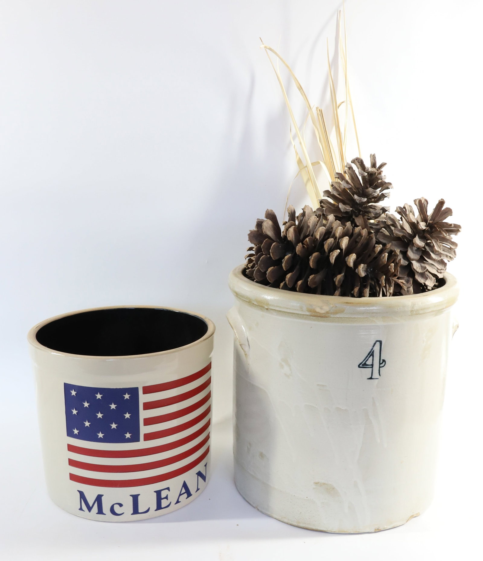 (2) STONEWARE CROCKS: 4 GALLON CROCK WITH PINECONES - 12" H AND STONEWARE CROCK WITH FLAG MARKED; MCLEAN 9" H Terms: PLEASE READ CAREFULLY -THIS IS AN ONLINE ONLY AUCTION. Terms for Purchasing and Shipping of Auction Items