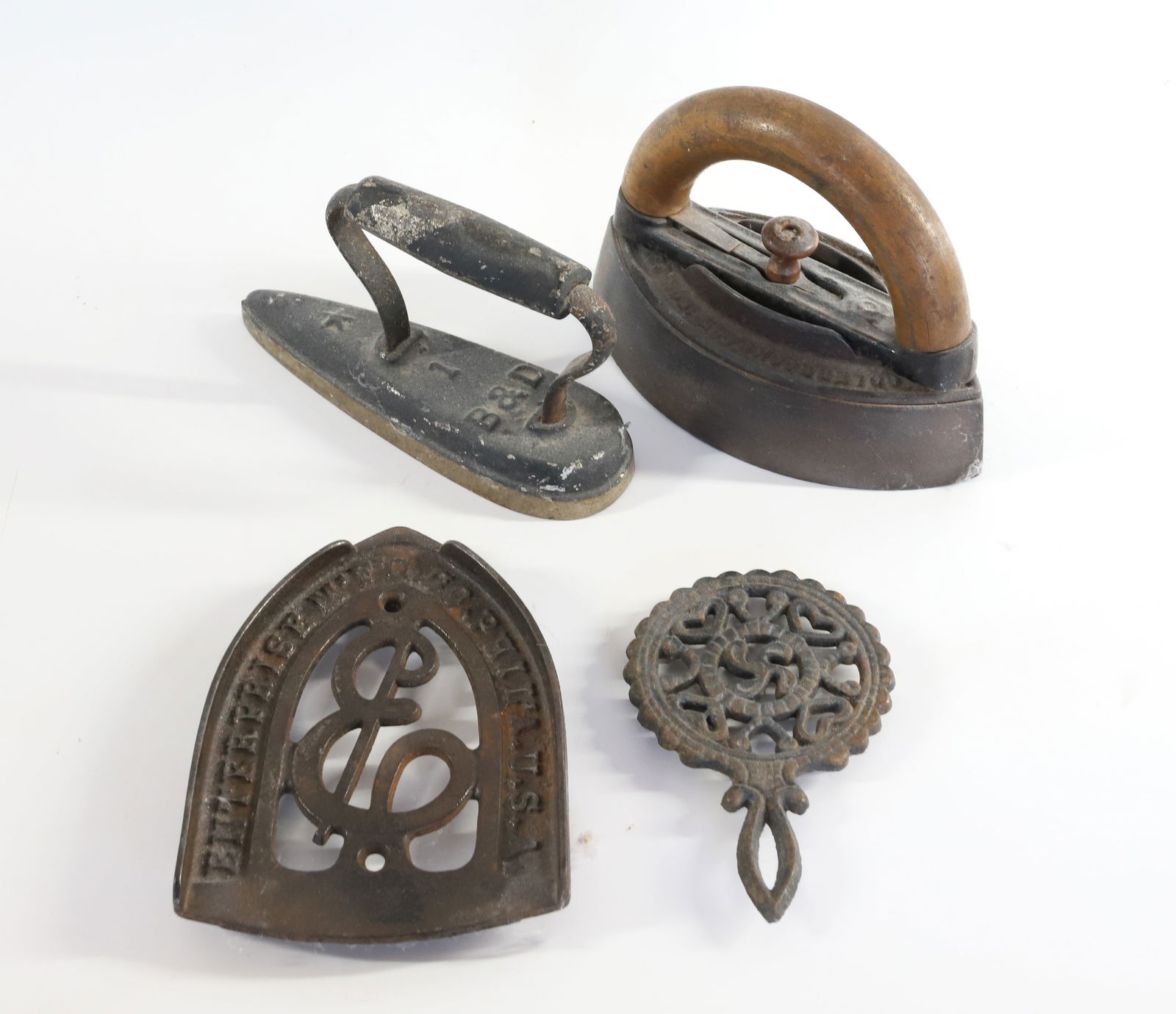 LOT OF ANTIQUE IRONS AND TRIVETS: LARGEST 7" L Terms: PLEASE READ CAREFULLY -THIS IS AN ONLINE ONLY AUCTION. Terms for Purchasing and Shipping of Auction Items. Please read carefully before bidding. All payments for purchases will be
