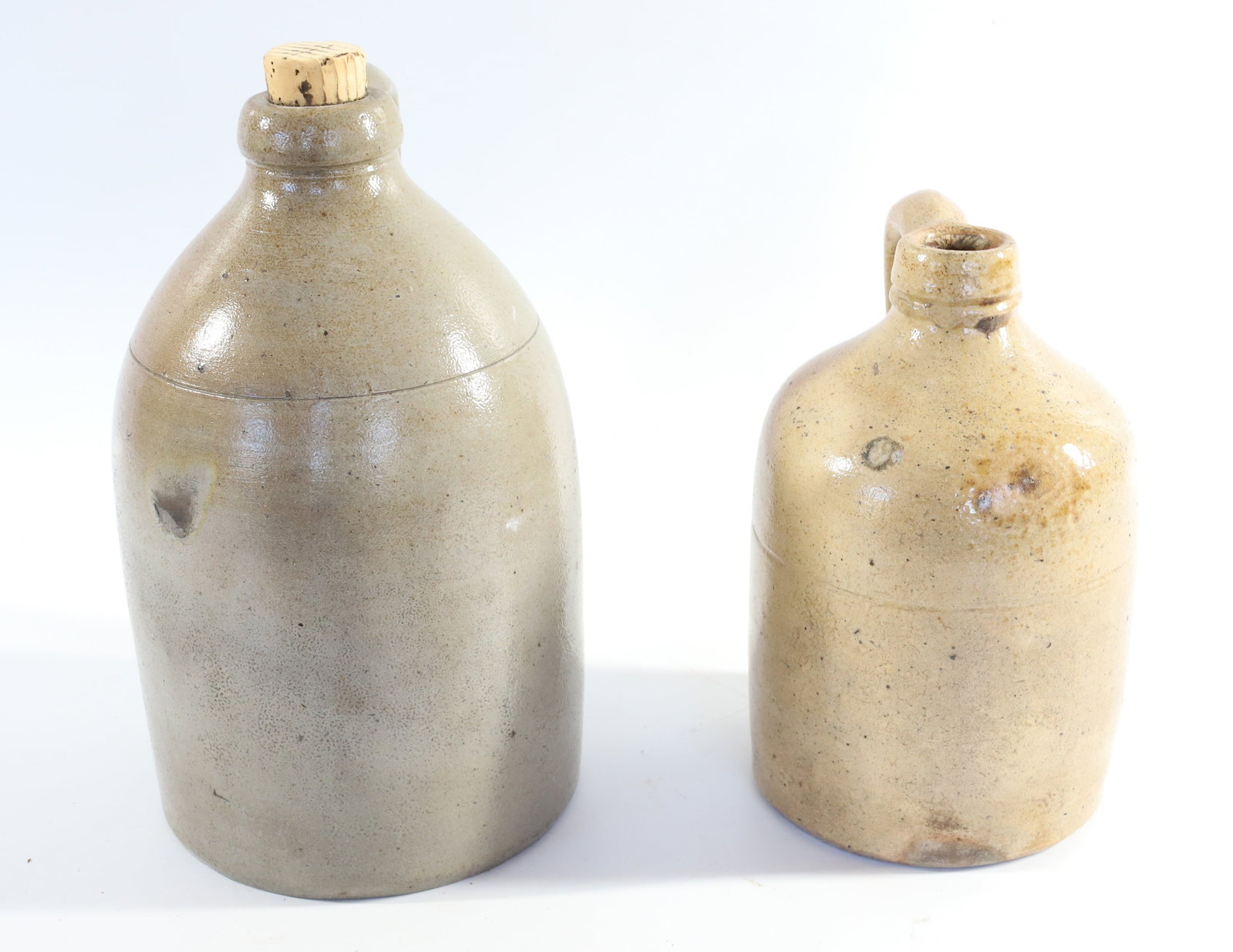 (2) ANTIQUE STONEWARE JUGS: STRAP HANDLES, 7 1/4" AND 9" H Terms: PLEASE READ CAREFULLY -THIS IS AN ONLINE ONLY AUCTION. Terms for Purchasing and Shipping of Auction Items. Please read carefully before bidding. All payments for 