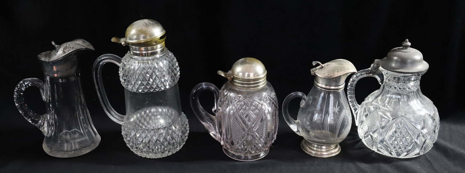 VICTORIAN SYRUP LOT: (5) SYRUPS, WITH SILVER PLATED TOPS, PRESSED GLASS - 7 1/4" TALLEST Terms: PLEASE READ CAREFULLY -THIS IS AN ONLINE ONLY AUCTION. Terms for Purchasing and Shipping of Auction Items. Please read carefu