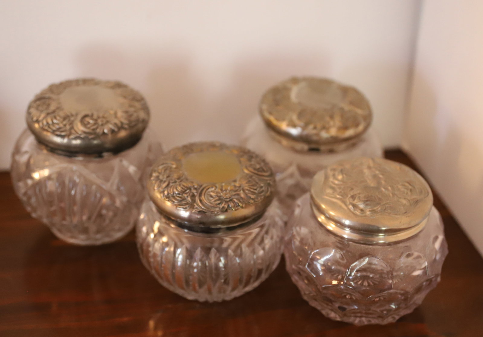 CUT GLASS HAIR RECEIVER AND POWDERS JARS: (4) WITH SILVER PLATED LIDS - 4 1/2" LARGEST Terms: PLEASE READ CAREFULLY -THIS IS AN ONLINE ONLY AUCTION. Terms for Purchasing and Shipping of Auction Items. Please read carefully before bidding. All