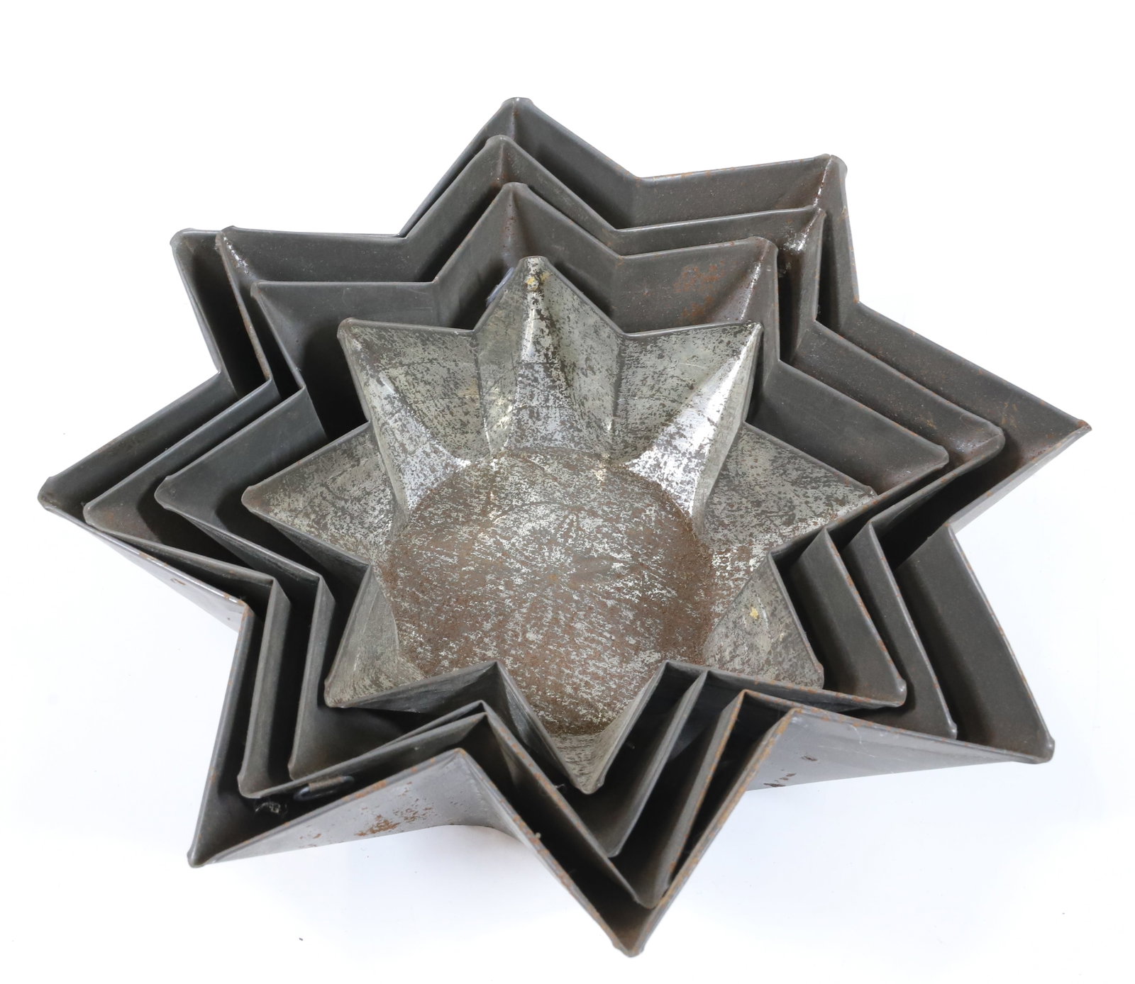 NEST OF TIN STAR MOLDS: (4) EIGHT POINT STARS WITH DESIGNS IN BOTTOM. 6 1/2" TO 10 1/2" D. PLEASE READ CAREFULLY -THIS IS AN ONLINE ONLY AUCTION. WE WILL BE TAKING ABSENTEE AND PHONE BIDS ALSO. Terms for Purchasing and Shipp
