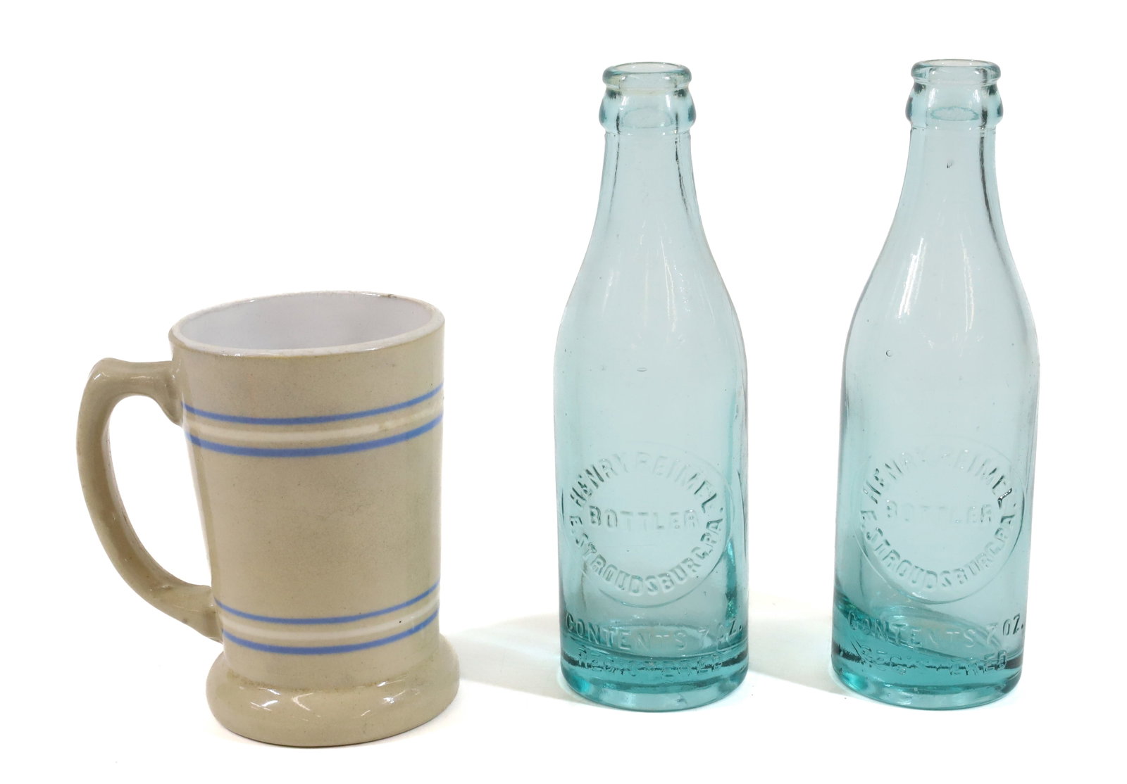 (2) EAST STROUDSBURG BOTTLES AND STONEWARE MUG: (2) HENRY REIMEL AQUA BOTTLES AND BANDED STONEWARE MUG 4 3/4" H. PLEASE READ CAREFULLY -THIS IS AN ONLINE ONLY AUCTION. WE WILL BE TAKING ABSENTEE AND PHONE BIDS ALSO. Terms for Purchasing and Shippin