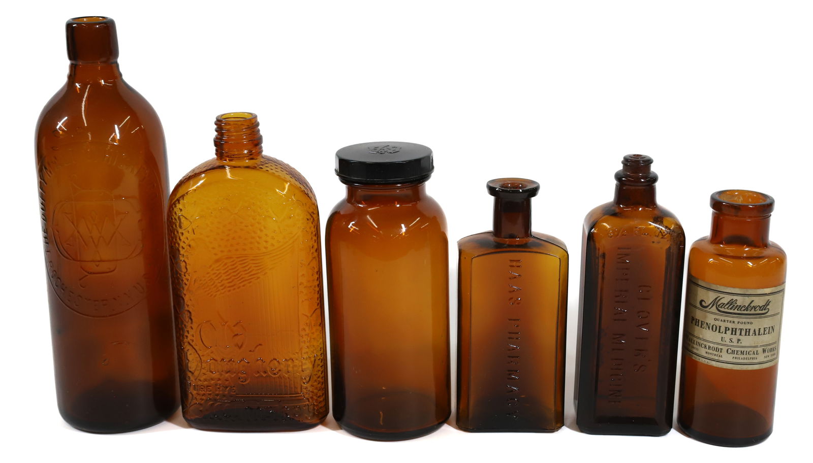 LOT OF AMBER BOTTLES: INCLUDING: OLD DOUGHERRY RYE, DUFFY MALT WHISKEY, MALLINCKRODT WITH PAPER LABEL, HAAS PHARMACY, CLOVER'S IMPERIAL MEDICINE AND MORE. 6" TO 10" HEIGHT. PLEASE READ CAREFULLY -THIS IS AN ONLINE ONLY AUC