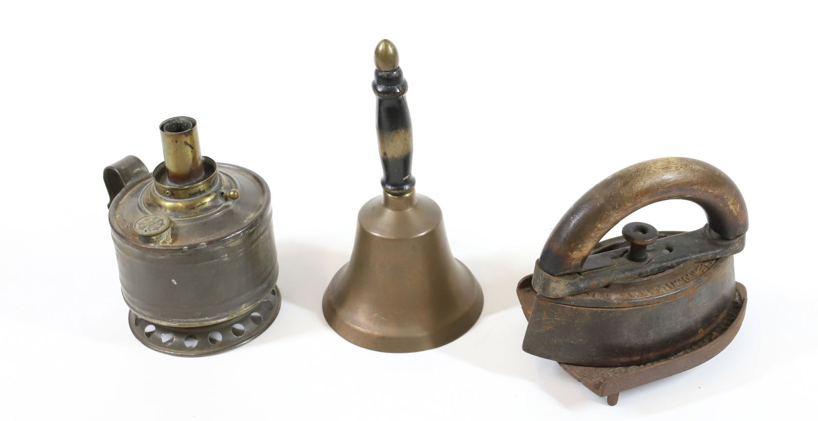 TIN LAMP, BRASS BELL AND SAD IRON: "THE HOME LAMP", BRASS BELL WITH WOODEN GRIP 8" H. AND SAD IRON WITH TRIVET. PLEASE READ CAREFULLY -THIS IS AN ONLINE ONLY AUCTION. WE WILL BE TAKING ABSENTEE AND PHONE BIDS ALSO. Terms for Purchasing