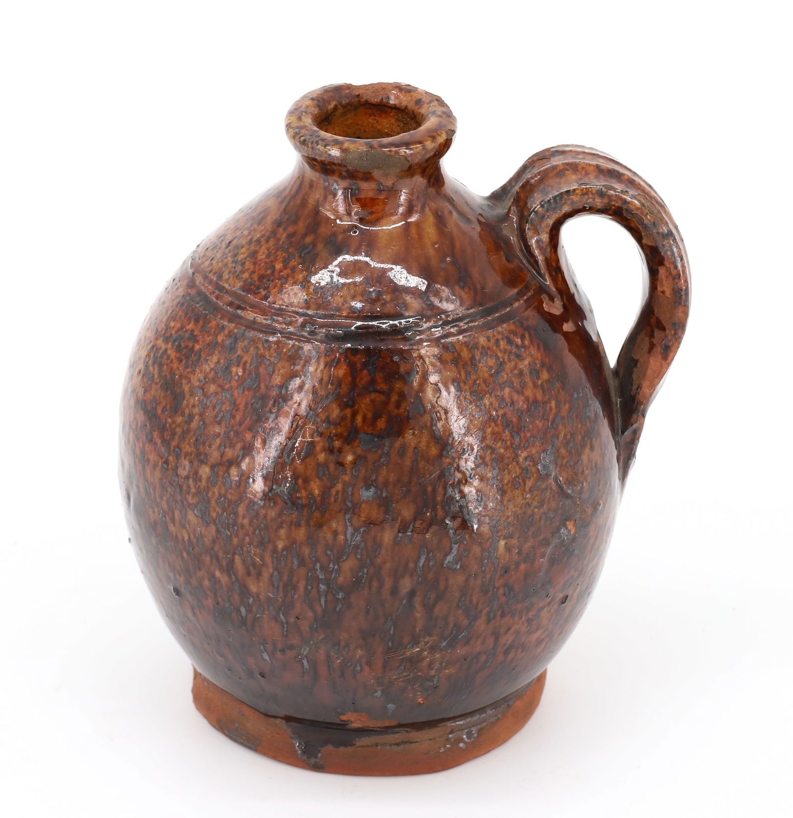 REDWARE PETITE GLAZED JUG: OVOID SHAPE WITH BROWN STREAKY/SPECKLED GLAZE. STRAP HANDLE. 4 3/4" H. PLEASE READ CAREFULLY - Terms for Purchasing and Shipping of Auction Items. Please read carefully before bidding. All payments fo