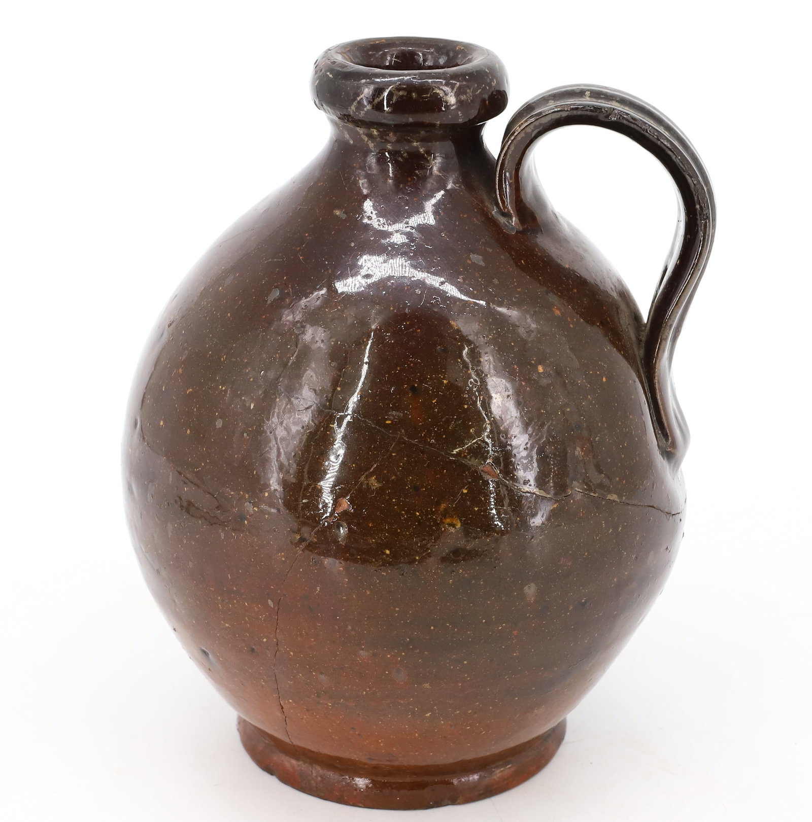 PETITE REDWARE JUG: BALL SHAPED WITH VARYING BROWN GLAZE AND APPLIED STRAP HANDLE. 6 1/2" H. PLEASE READ CAREFULLY - Terms for Purchasing and Shipping of Auction Items. Please read carefully before bidding. All payments