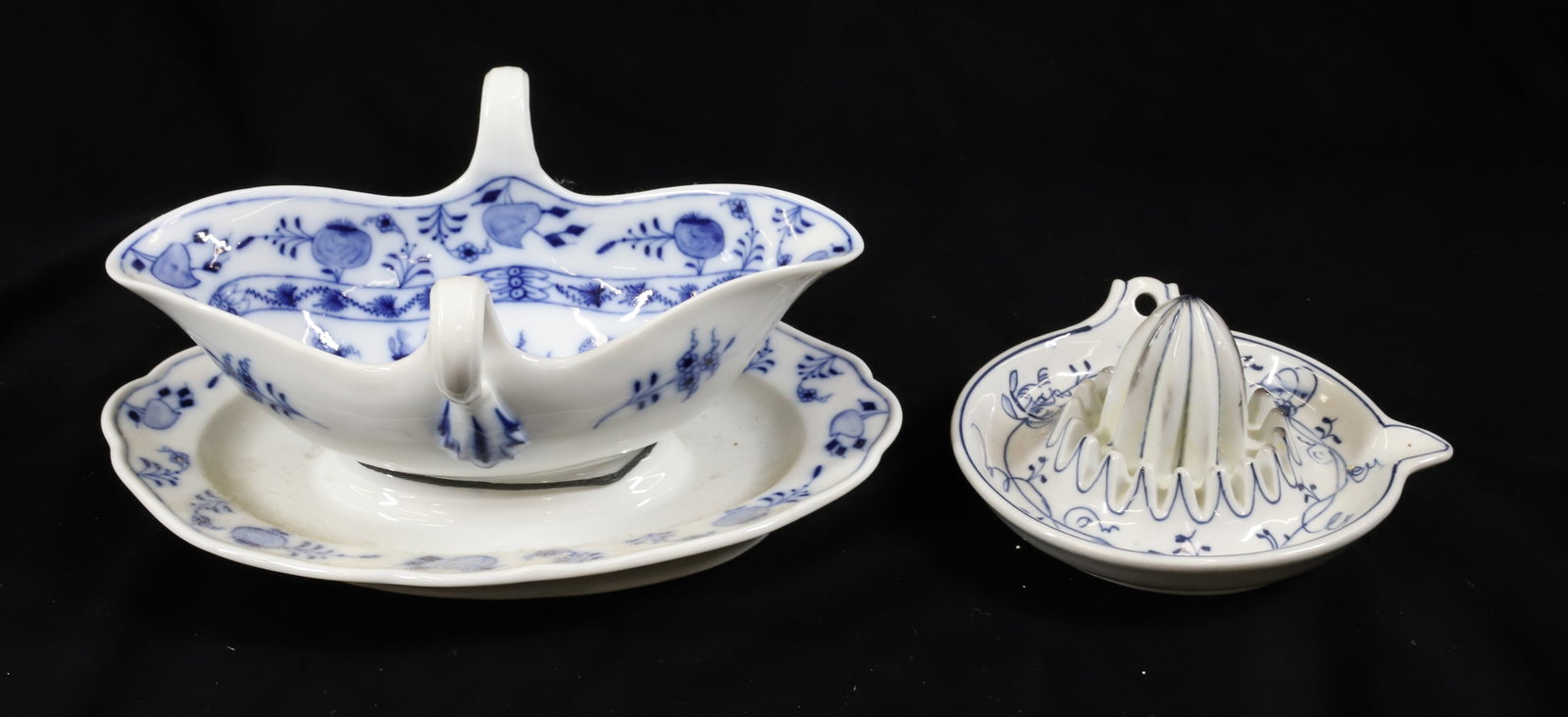 (2) MEISSEN BLUE ONION GRAVY BOAT AND LEMON SQUEEZER: DOUBLE HANDLE GRAVY BOAT WITH ATTACHED UNDERPLATE AND FRUIT SQUEEZER UNMARKED 4 1/2" X 9 3/4", 5 1/2" DIA PLEASE READ CAREFULLY - Terms for Purchasing and Shipping of Auction Items. Please read carefu