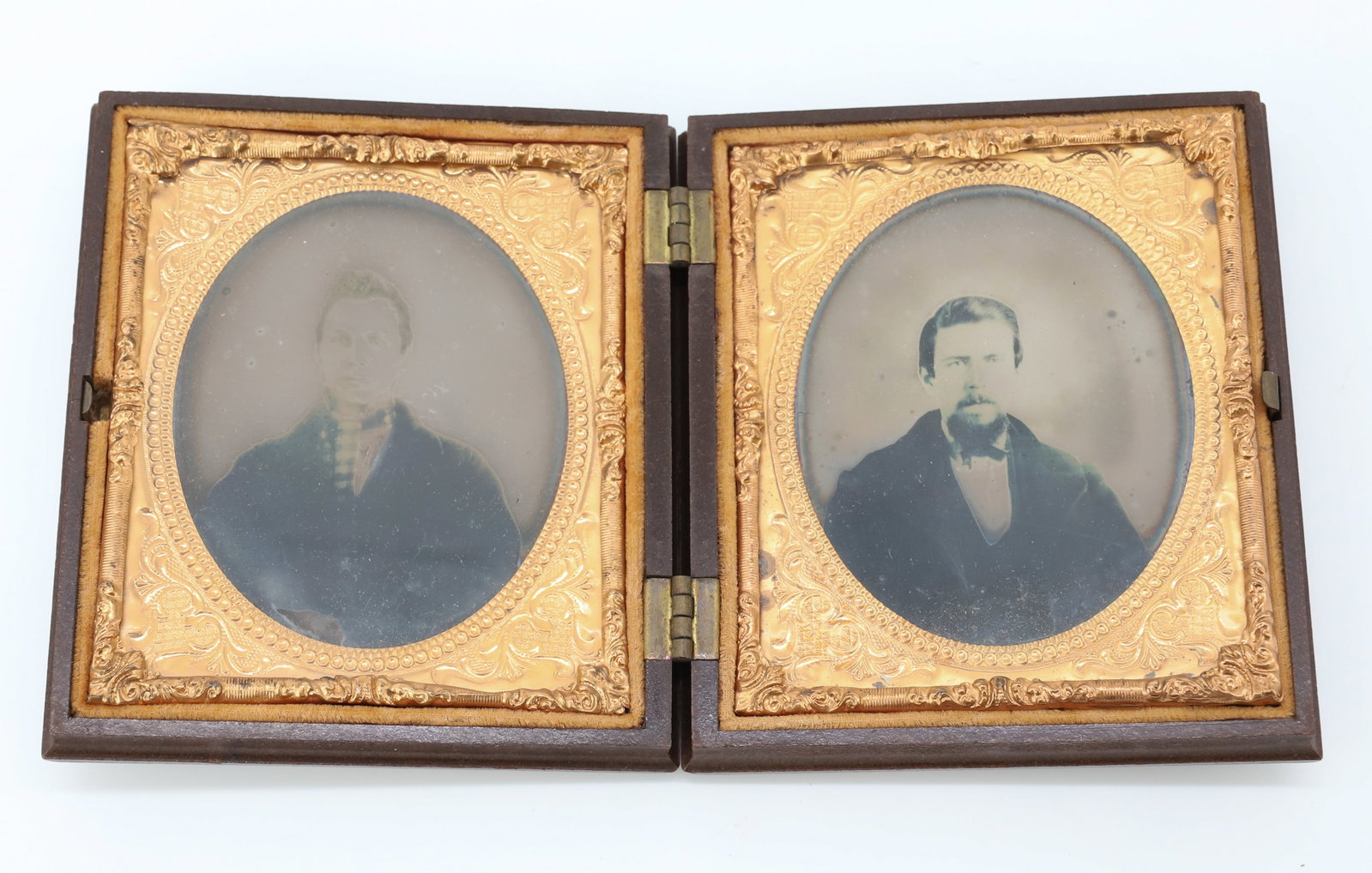 (2) AMBROTYPES IN SINGLE CASE: GENTLEMAN ON EITHER SIDE, CASE EMBOSSED WITH FLORAL BOUQUET - IMAGES 3 1/4" X 2 3/4" PLEASE READ CAREFULLY - Terms for Purchasing and Shipping of Auction Items. Please read carefully before bidding. A