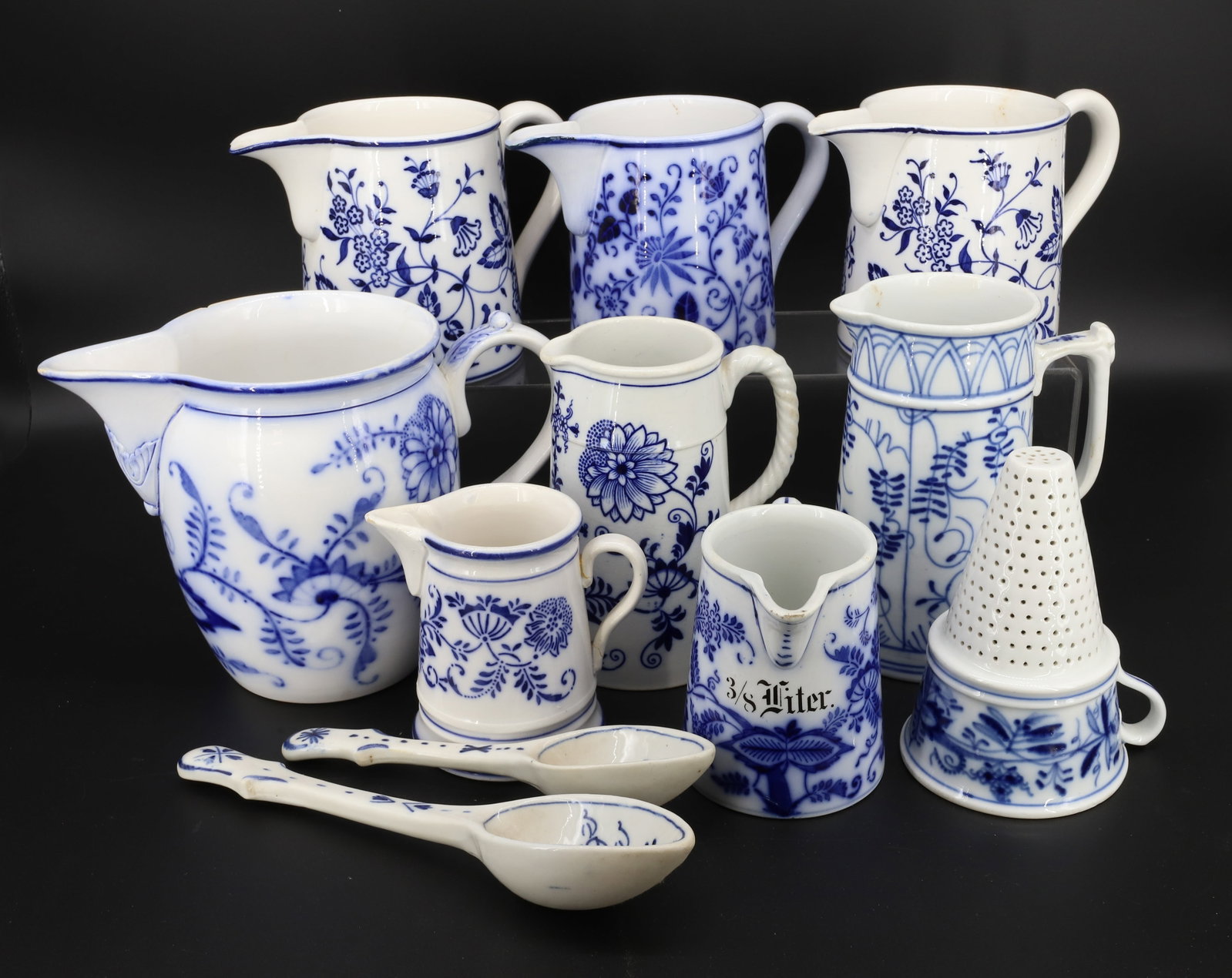 (11) BLUE ONION PITCHER GROUP: TWO SPOONS, ONE FUNNEL AND (8) PITCHERS VARYING SIZES AND MFG. 4 1/4" TO 6 3/4"