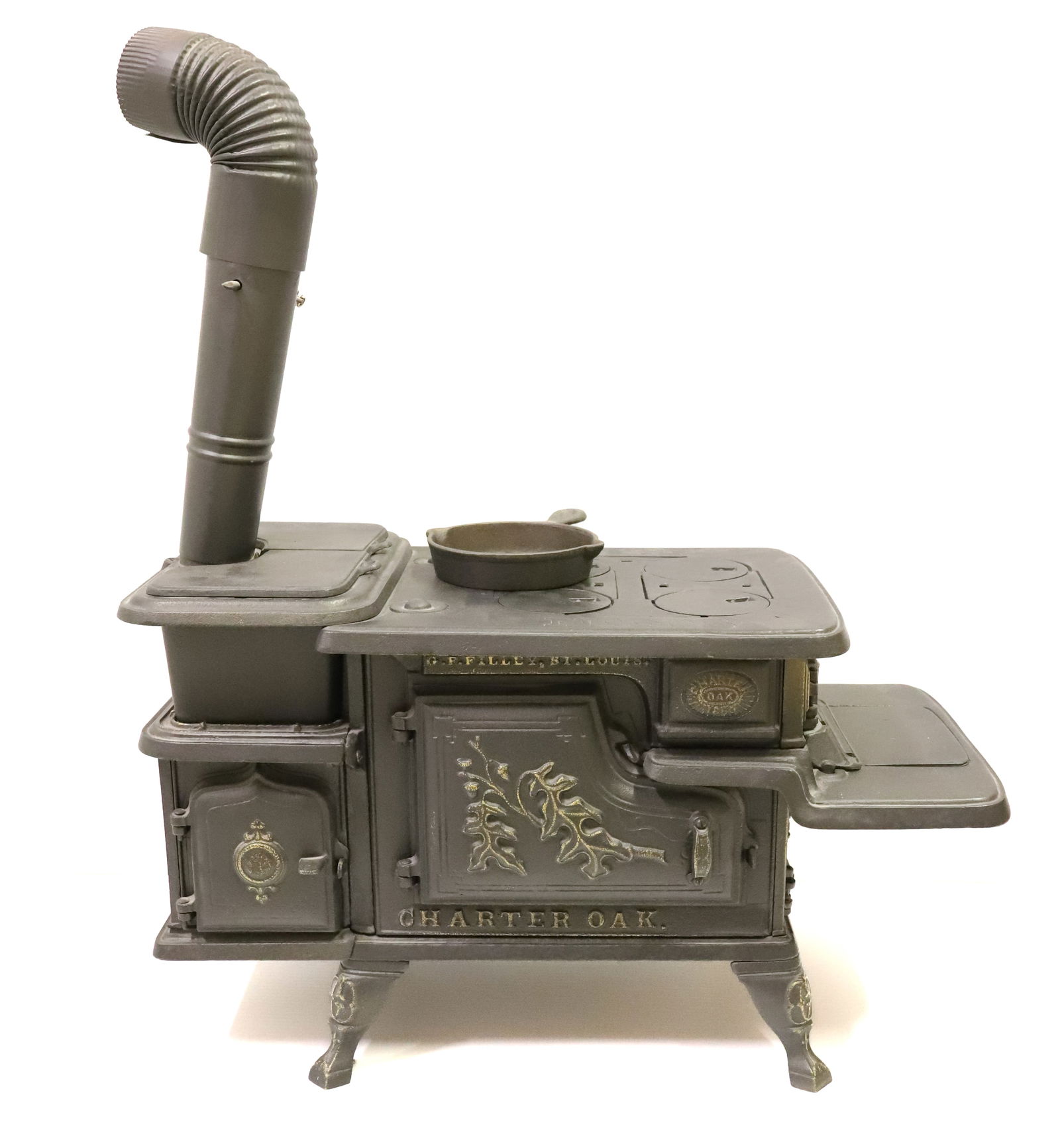 CHARTER OAK NO. 503 CAST IRON CHILD'S STOVE: CAST IRON WITH PAINTED HIGHLIGHTS. MRKD. "G.F. FILLEY, ST. LOUIS". ONE DOOR MRKD. PAT'D 1881. SIDE DOOR MRKD. "PAT EXTENDED JUNE 14, 1867". FOUR BURNER PLATES. 15" X 26" X 12". PLEASE READ CAREFULLY -