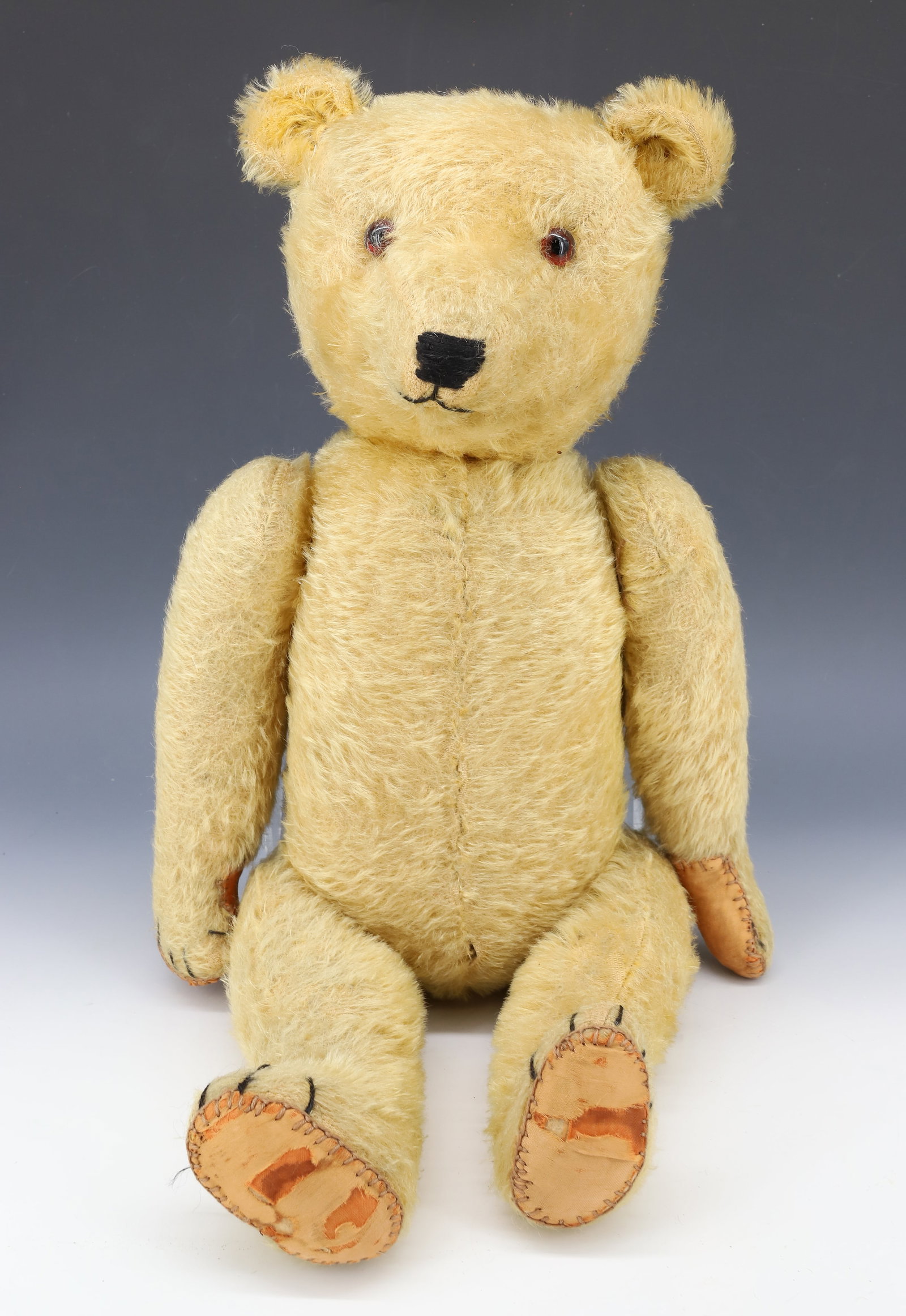ANTIQUE JOINTED TEDDY BEAR: MOHAIR "GROWLER" BEAR WITH JOINTED BODY AND GLASS EYES. 22" L. PLEASE READ CAREFULLY - Terms for Purchasing and Shipping of Auction Items. Please read carefully before bidding. All payments for purcha