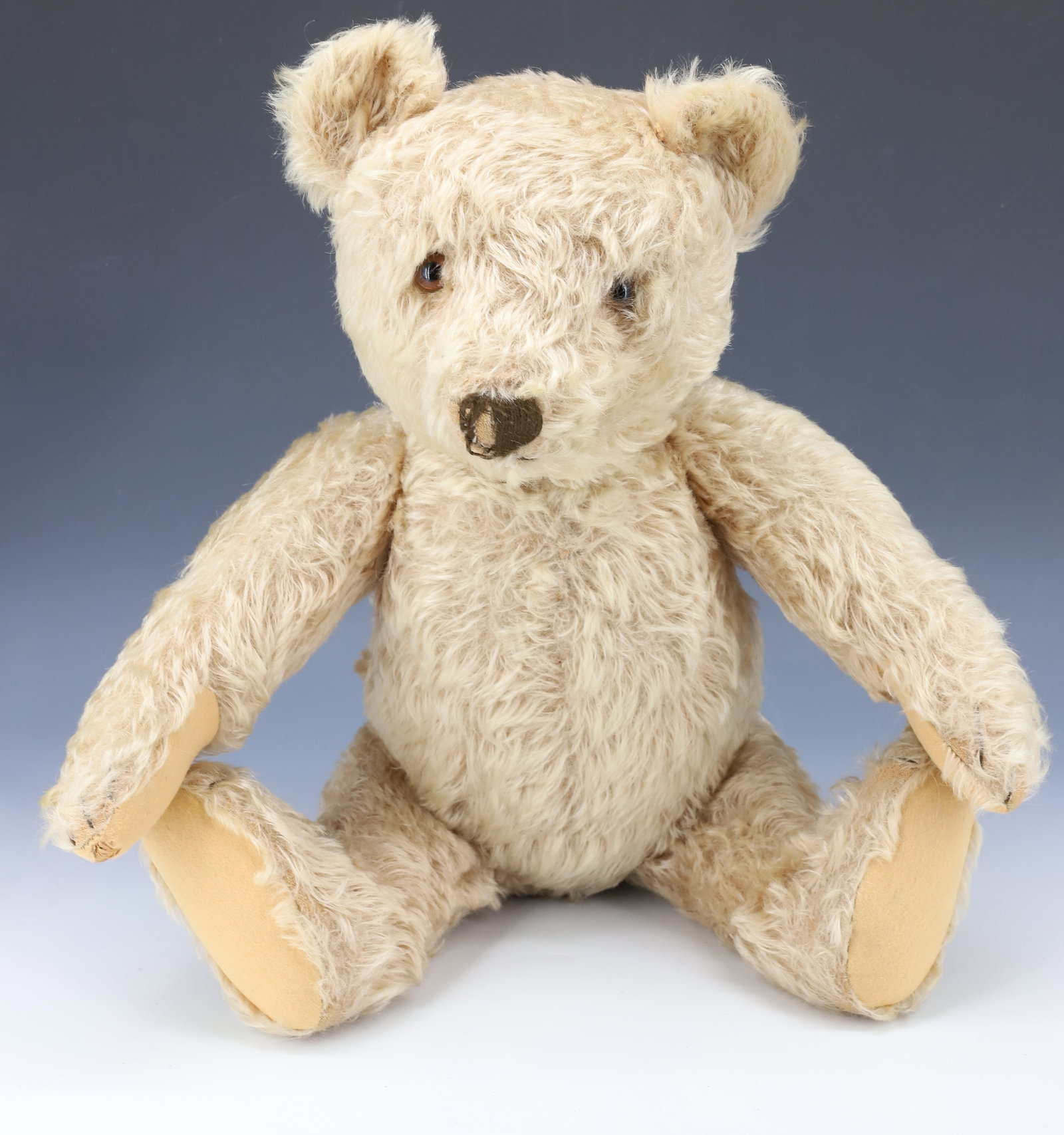 ANTIQUE JOINTED TEDDY BEAR: MOHAIR "GROWLER" BEAR WITH JOINTED BODY AND GLASS EYES. 19" L. PLEASE READ CAREFULLY - Terms for Purchasing and Shipping of Auction Items. Please read carefully before bidding. All payments for purcha