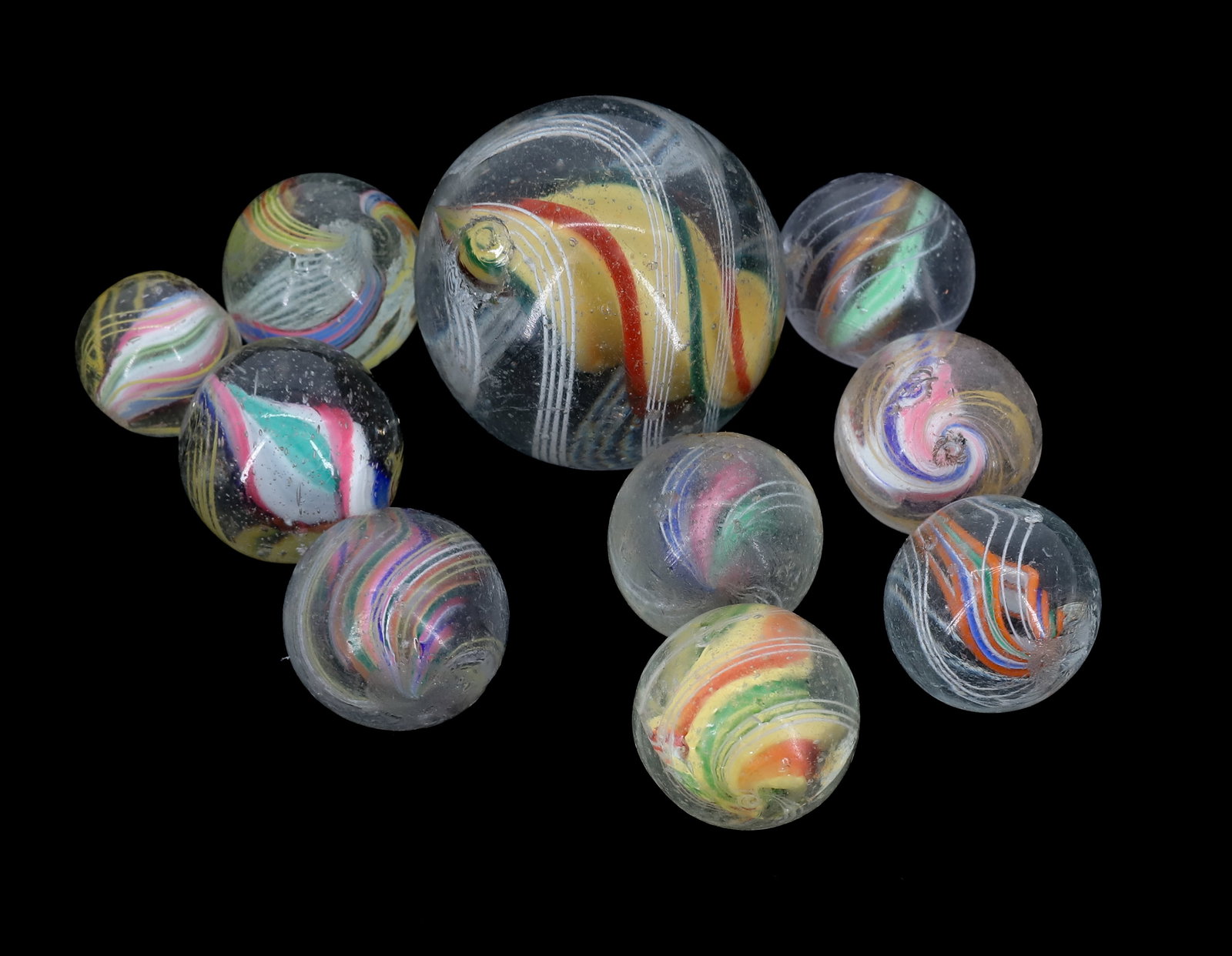 LOT OF (10) GLASS MARBLES: VARIOUS SIZE MARBLES WITH COLORED CORES. LARGEST 1 1/8". PLEASE READ CAREFULLY - Terms for Purchasing and Shipping of Auction Items. Please read carefully before bidding. All payments for purchases wi