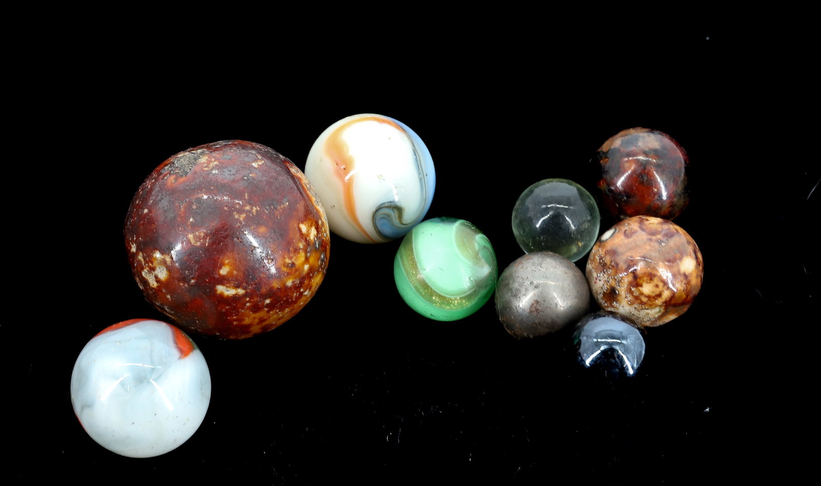 LOT OF (9) VARIOUS MARBLES: ROCKINGHAM GLAZE CLAY AND GLASS. LARGEST 1 1/4" D. PLEASE READ CAREFULLY - Terms for Purchasing and Shipping of Auction Items. Please read carefully before bidding. All payments for purchases will be 