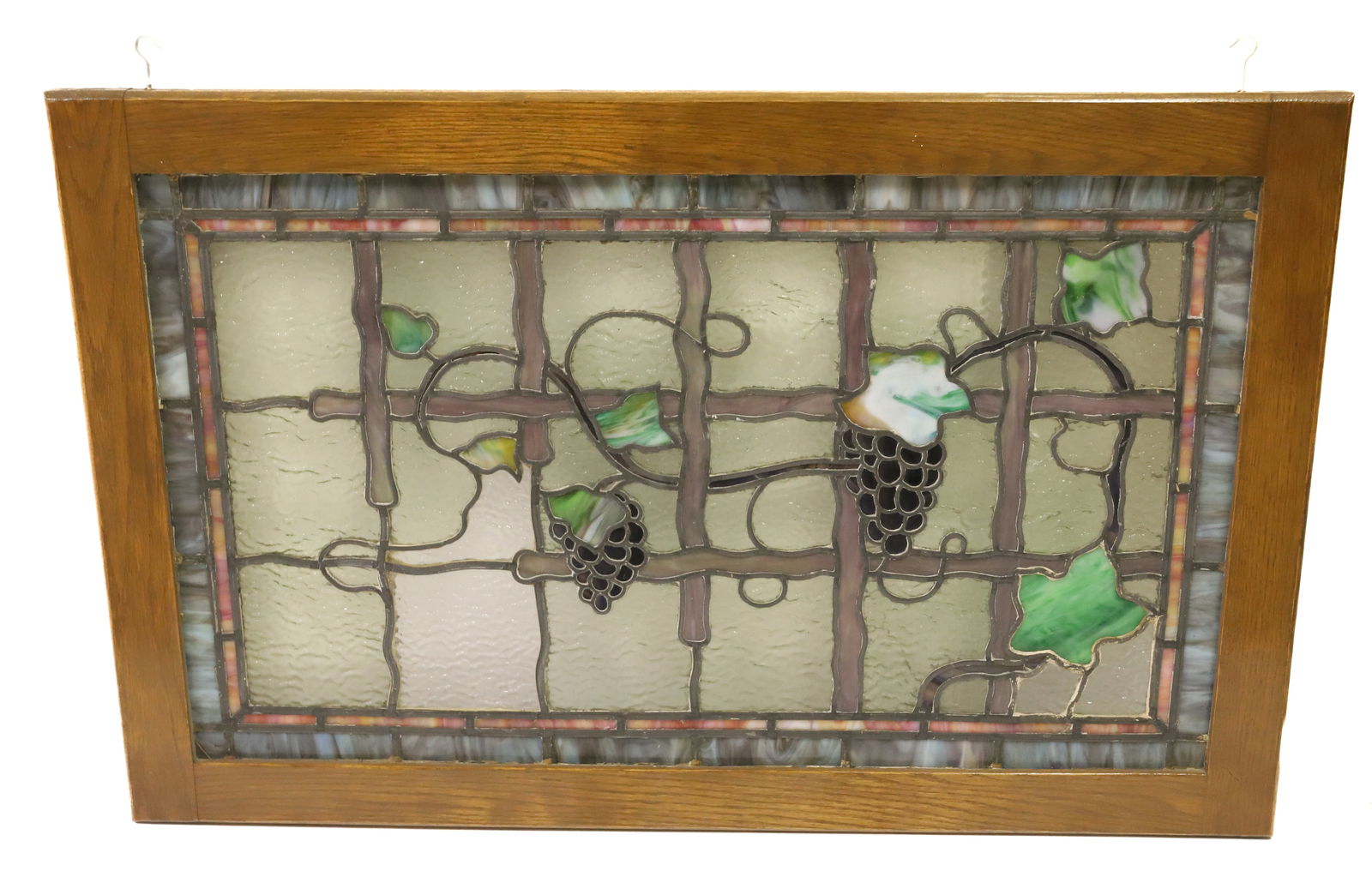 FRAMED STAINED GLASS PANEL: PAIR OF GRAPE BUNCHES ON VINES. TOTAL SIZE 22 1/2" X 36". PLEASE READ CAREFULLY - Terms for Purchasing and Shipping of Auction Items. Please read carefully before bidding. All payments for purchases w