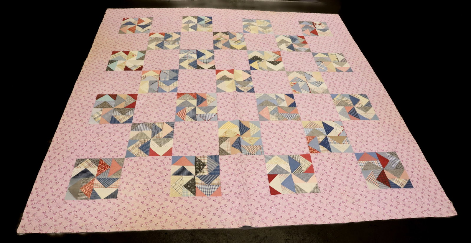 VINTAGE HAND STITCHED QUILT: BLOCK PATTERN WITH FLORAL. BLUE/WHITE CHECK BACKING. 83" X 82". PLEASE READ CAREFULLY - Terms for Purchasing and Shipping of Auction Items. Please read carefully before bidding. All payments for purch