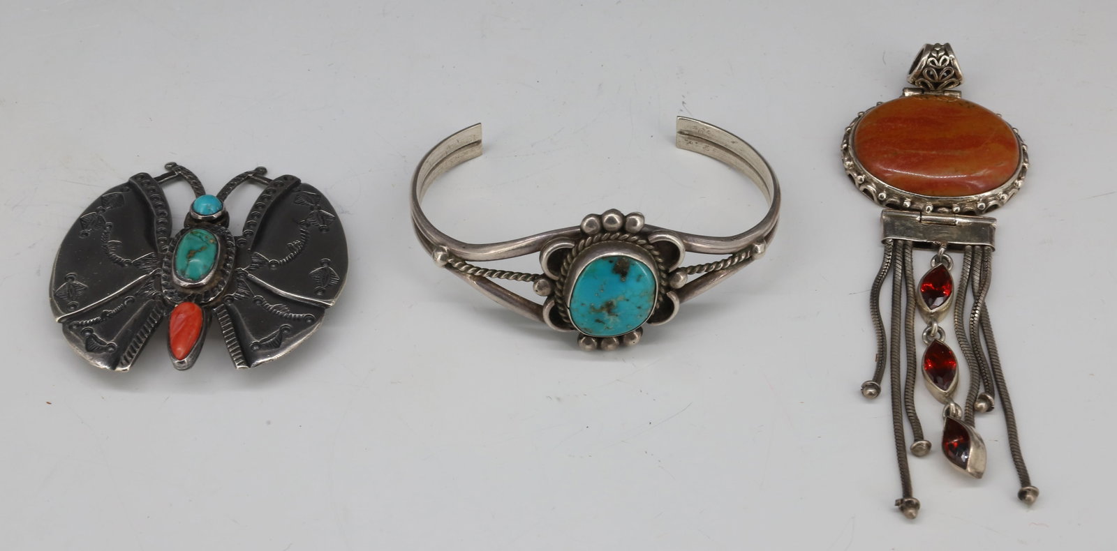 NATIVE AMERICAN JEWELRY LOT: (3) PIECES INCLUDING; SILVER BRACELET WITH TURQUOISE CENTER STONE (UNMARKED) 2 1/2", SILVER PENDANT WITH ORANGE STONE (UNMARKED), AND MEXICAN SILVER PIN WITH STONE DECORATION PLEASE READ CAREFULLY - T