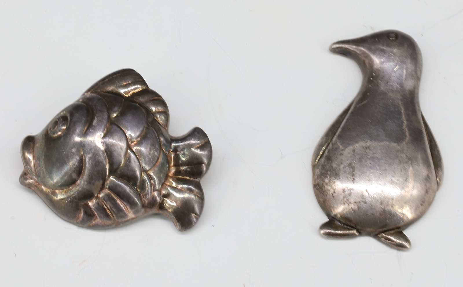 STERLING FISH AND PENGUIN PINS: BOTH MARKED 925 - PENGUIN 2" PLEASE READ CAREFULLY - Terms for Purchasing and Shipping of Auction Items. Please read carefully before bidding. All payments for purchases will be made through LiveAucti