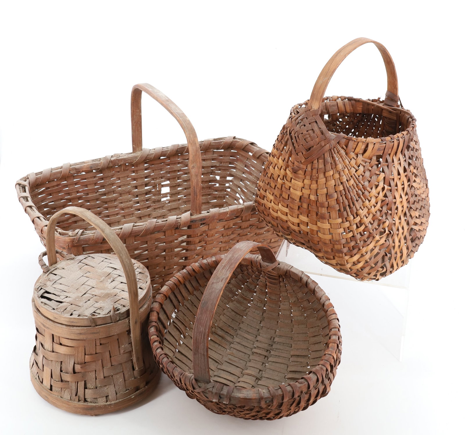 LOT OF COUNTRY BASKETS: FOUR ANTIQUE BASKETS INCLUDING: MELON SHAPED BASKET 9 1/4" D., UNUSUAL SHAPED FLOWER BASKET 12" TOTAL HEIGHT, FIRKIN-SHAPED BASKET AND RECTANGULAR GATHERING BASKET 17" L. PLEASE READ CAREFULLY - Terms