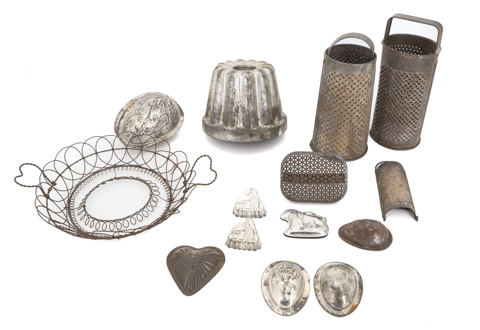 LOT OF TINWARE: TWO ROUND GRATERS (ONE PAT'D 1897) 9 1/4" H., VARIOUS CHOCOLATE MOLDS (LARGEST 5 1/2" D.) AND WIRE BASKET. PLEASE READ CAREFULLY - Terms for Purchasing and Shipping of Auction Items. Please read caref