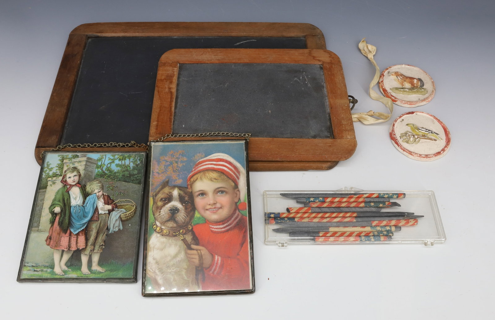 SCHOOL SLATE BOARDS, SLATE PENCILS AND MORE: TWO CHILD'S SLATE BOARDS (LARGEST 11 1/2" X 8"), RWB SLATE PENCILS, TWO CHALKWARE MEDALLIONS AND TWO FRAMED CARDS. PLEASE READ CAREFULLY - Terms for Purchasing and Shipping of Auction Items. Please re
