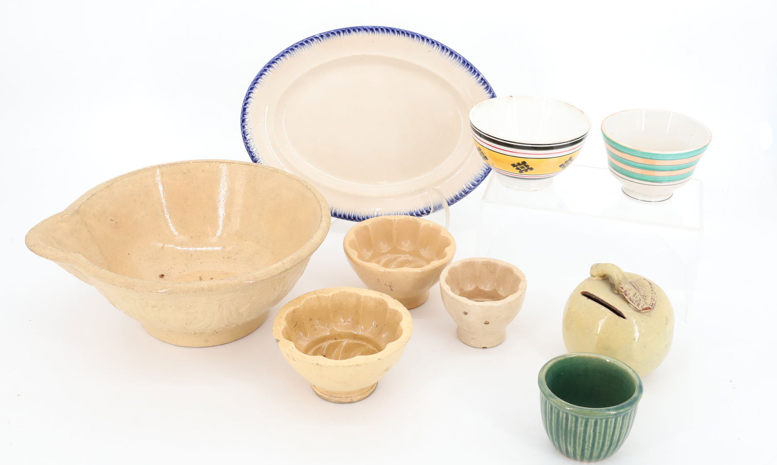 LOT OF VINTAGE POTTERY AND PORCELAIN: INCLUDING: THREE YELLOW WARE MOLDS AND BATTER BOWL, FEATHER EDGE PLATTER 10 3/4" L., POTTERY APPLE BANK, GREEN CUSTARD CUP AND TWO TEA BOWLS. PLEASE READ CAREFULLY - Terms for Purchasing and Shipping