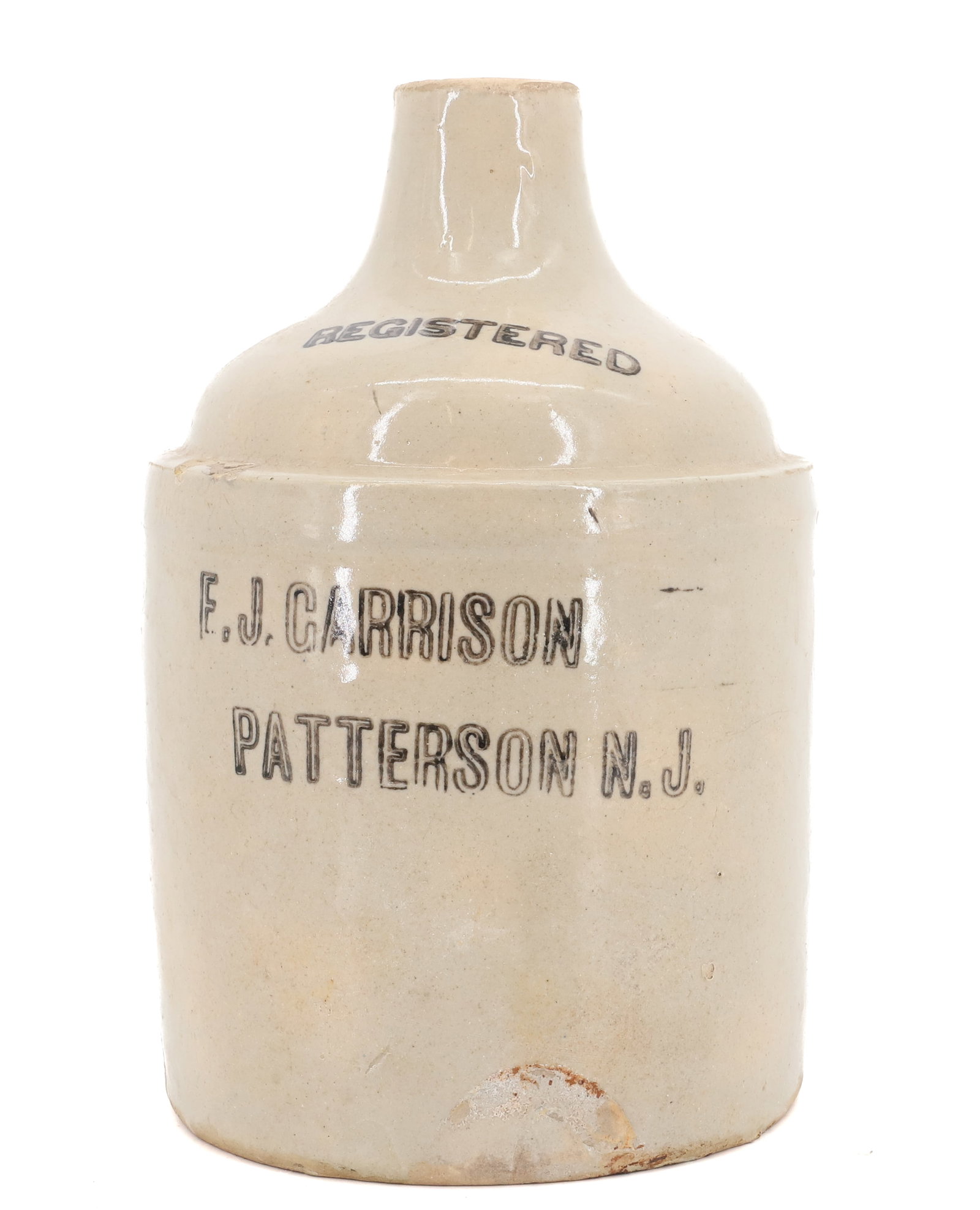 STONEWARE ADVERTISING JUG: HALF-GALLON "E.J GARRISON, PATTERSON, NJ". 8 3/4" H. PLEASE READ CAREFULLY - Terms for Purchasing and Shipping of Auction Items. Please read carefully before bidding. All payments for purchases will b