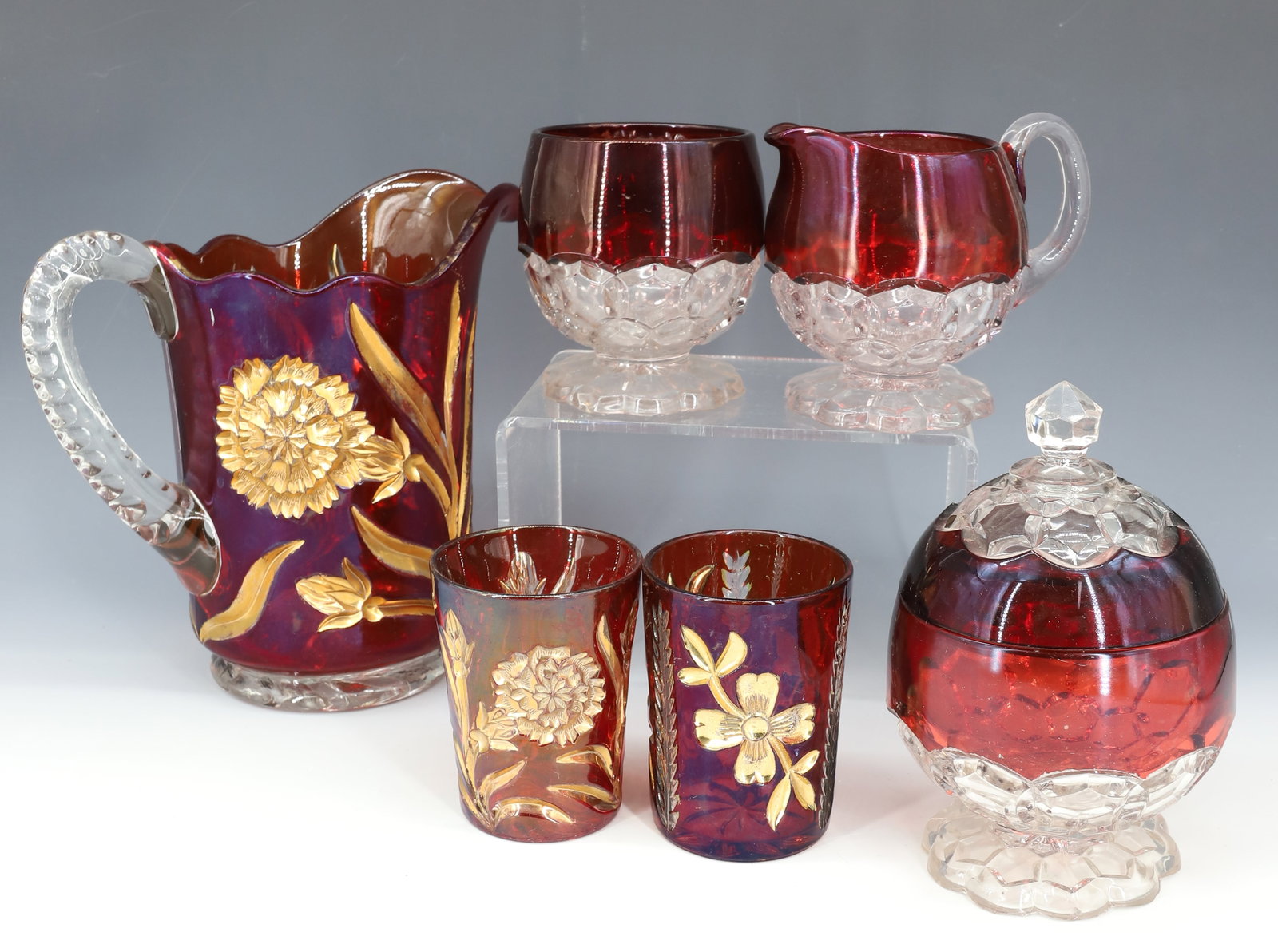 (6) EARLY AMERICAN PRESSED GLASS WITH RUBY FLASH DECORATION PITCHER, SUGAR,CREAMER TUMBLERS: (3) IN MATCHING PATTERN SUGAR,CREAMER AND SPOONER, PITCHER AND TWO TUMBLERS IN MATCHING PATTERN WITH GOLD DECORATION 4" TO 8 1/2"H PLEASE READ CAREFULLY - Terms for Purchasing and Shipping of Auction 
