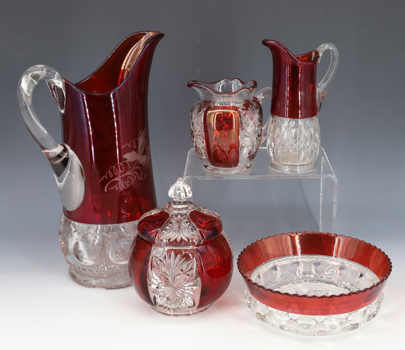 (5) EARLY AMERICAN PRESSED GLASS WITH RUBY FLASH COLOR, KINGS CROWN PITCHER, BOWL: INCLUDES KINGS CROWN PITCHER WITH ENGRAVING, BOWL, SUGAR AND CREAMER IN MATCHING PATTERN AND SMALL PITCHER 2 1/2" TO 6 1/2"H PITCHER 12"H PLEASE READ CAREFULLY - Terms for Purchasing and Shipping of A