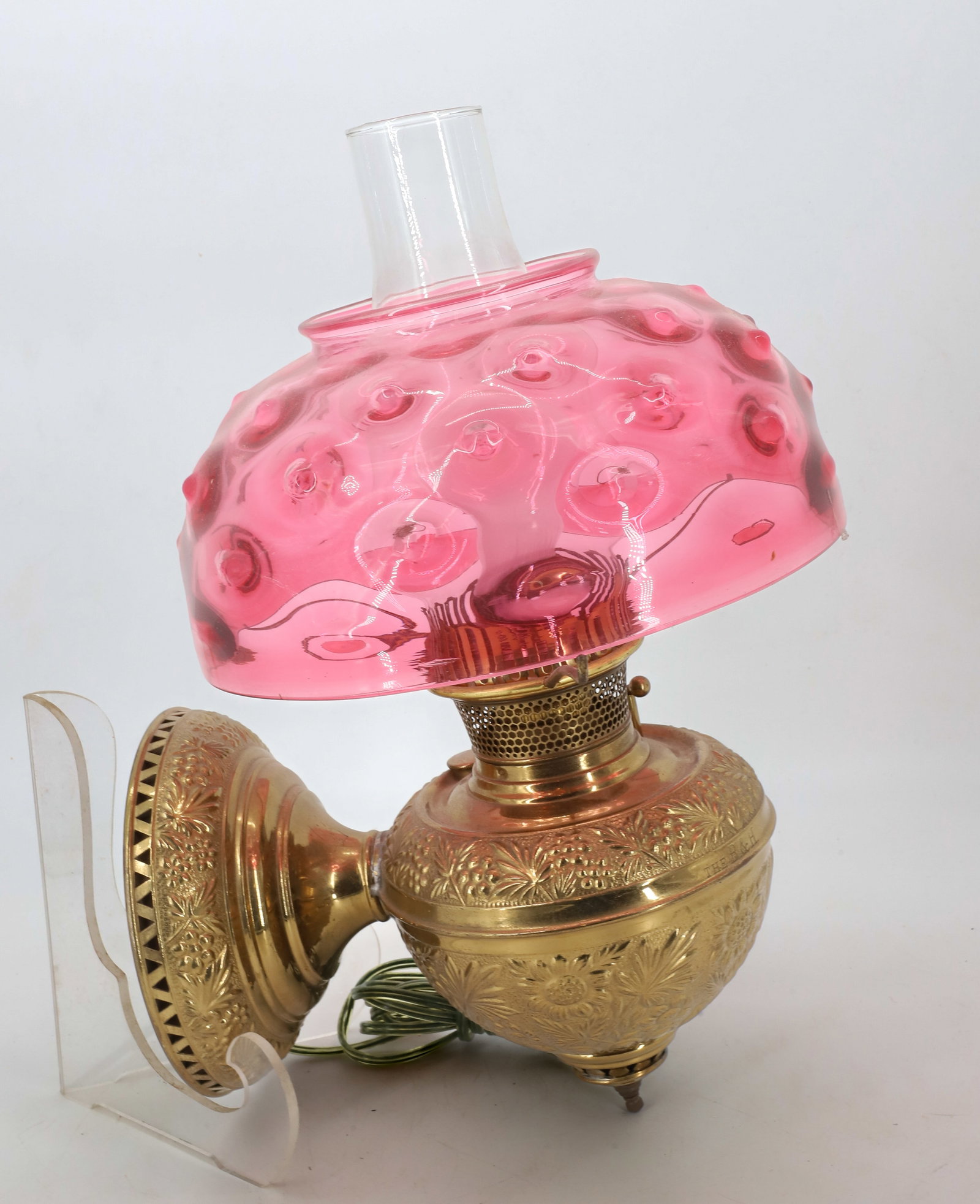 VICTORIAN BRASS WALL LAMP: CHANGED TO ELECTRIC, BRASS METAL WITH PALM AND FLOWER PATTERN, BLOWN GLASS SHADE CRANBERRY WITH UPPER FOLDED RIM 17"H X 12" PLEASE READ CAREFULLY - Terms for Purchasing and Shipping of Auction Items. 