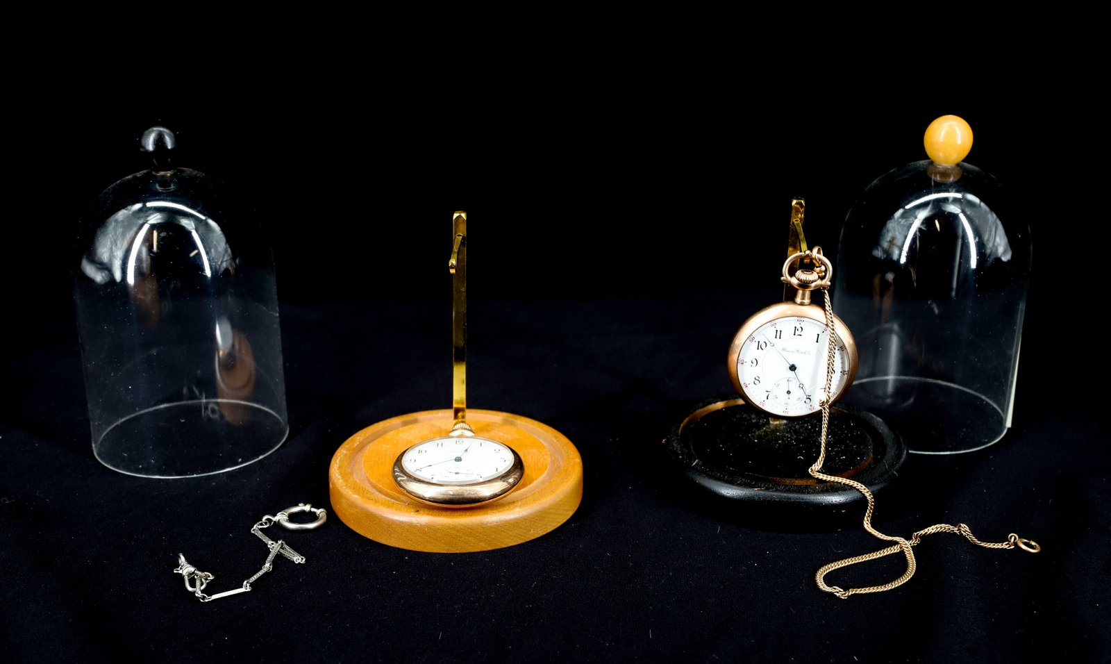 (2) ANTIQUE GOLD FILLED POCKET WATCHES: ELGIN, 17 JEWELS, WORKING MISSING BAIL, ILLINOIS WATCH CO. 17 JEWELS NOT WORKING BOTH WITH MONOGRAMS, ALSO TWO GOLD FILLED WATCH CHAINS YELLOW AND WHITE GOLD 13"L,7 1/4"L PLEXI DOMES WITH WATCH HOLDER