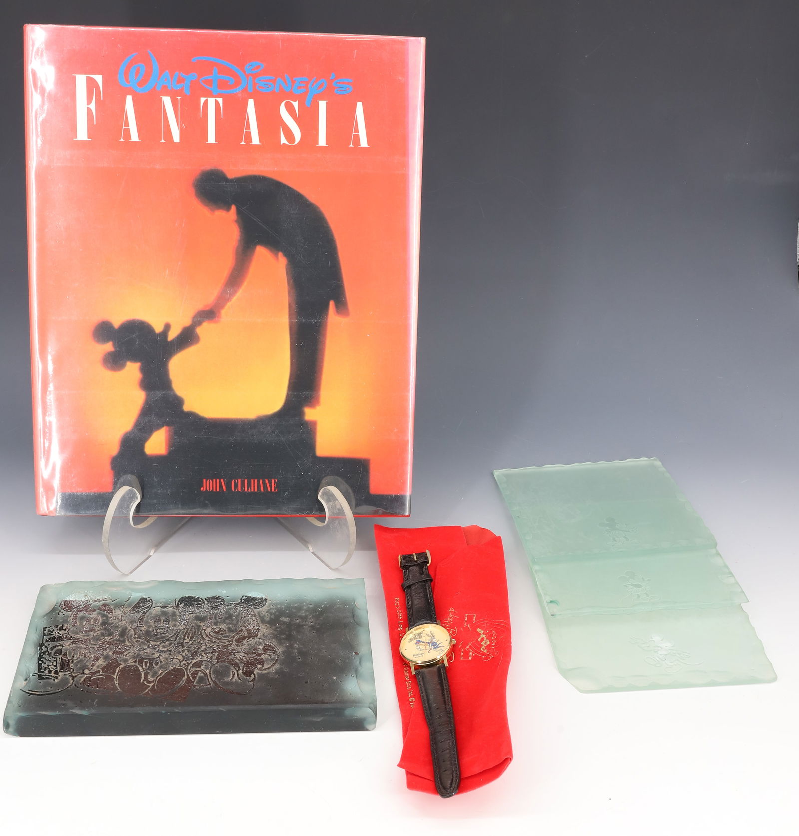 (6) WALT DISNEY FANTASIA BOOK, MICKEY MOUSE GLASS TILES: FANTASIA BOOK BY JOHN CULHANE, HARRY ABRAMS PUBLISHER, FOUR MICKEY MOUSE GLASS TILES AND BUGS BUNNY ARMITRON WATCH 12" X 9" PLEASE READ CAREFULLY - Terms for Purchasing and Shipping of Auction Items.