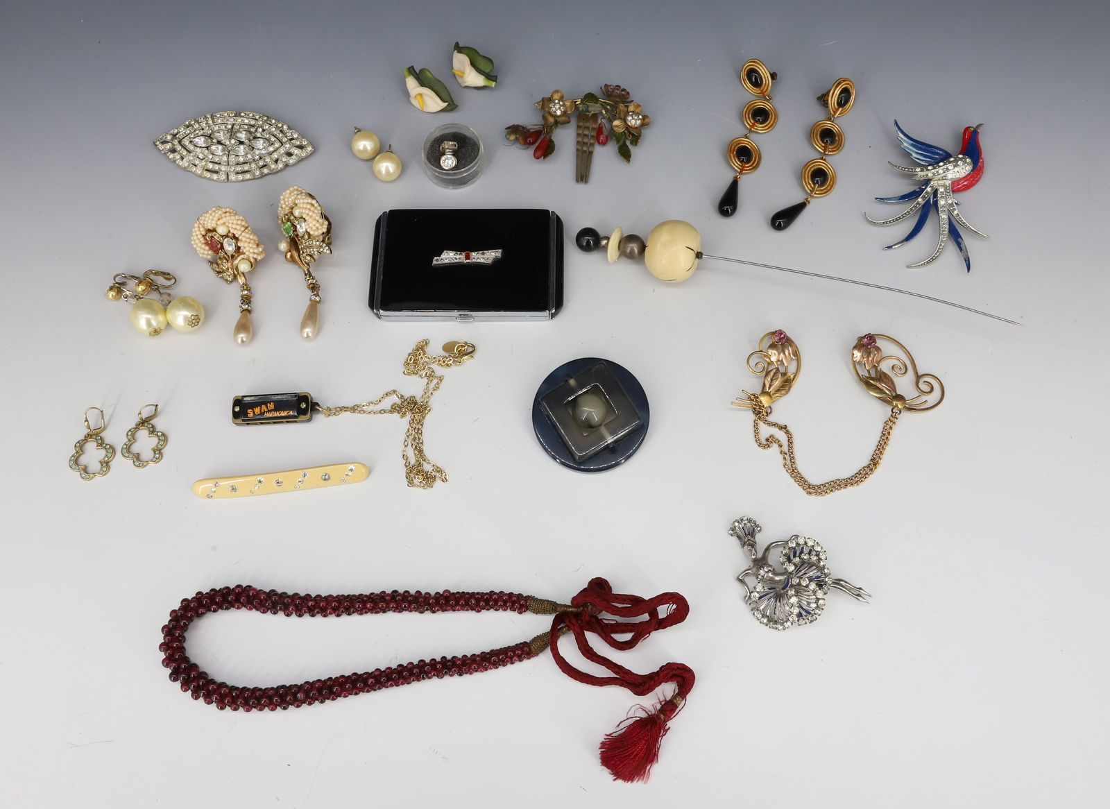 VINTAGE COSTUME JEWELRY LOT: BALLERINA BROOCH WITH PRONG SET RHINESTONES AND HEADRESS, LARGE BIRD BROOCH, GOLD FILLED PAIR BROOCHES, EVANS ART DECO COMPACT, WIRE CONSTRUCTED EARRINGS, SWAN HARMONICA PENDANT ETC BALLERINA 3 5/8"H